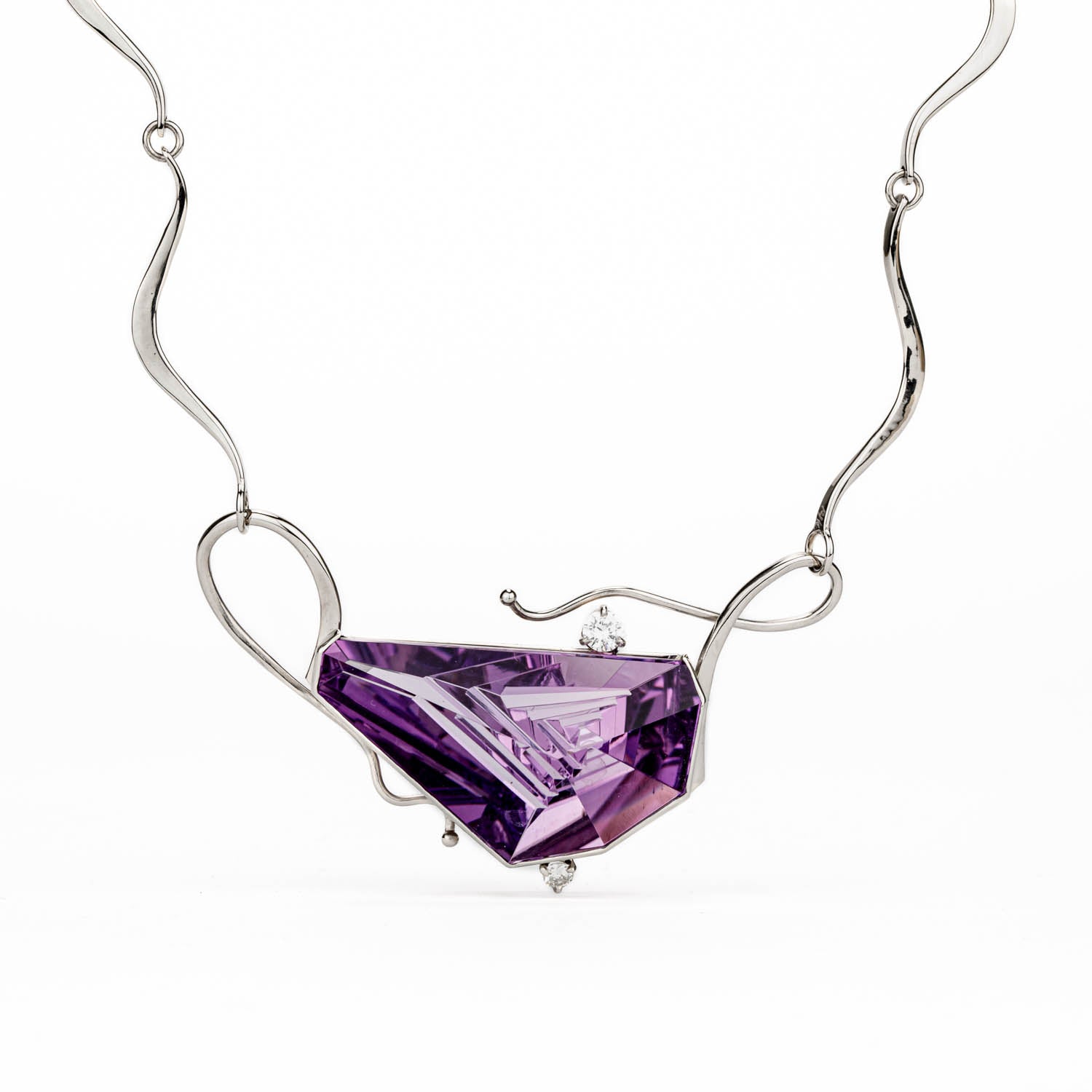 One-of-a-kind 14K white gold necklace featuring a 36.55-carat Munsteiner fantasy-cut amethyst in a hand-carved setting with prong-set pink and white diamonds, on a hand-forged wave-link chain
