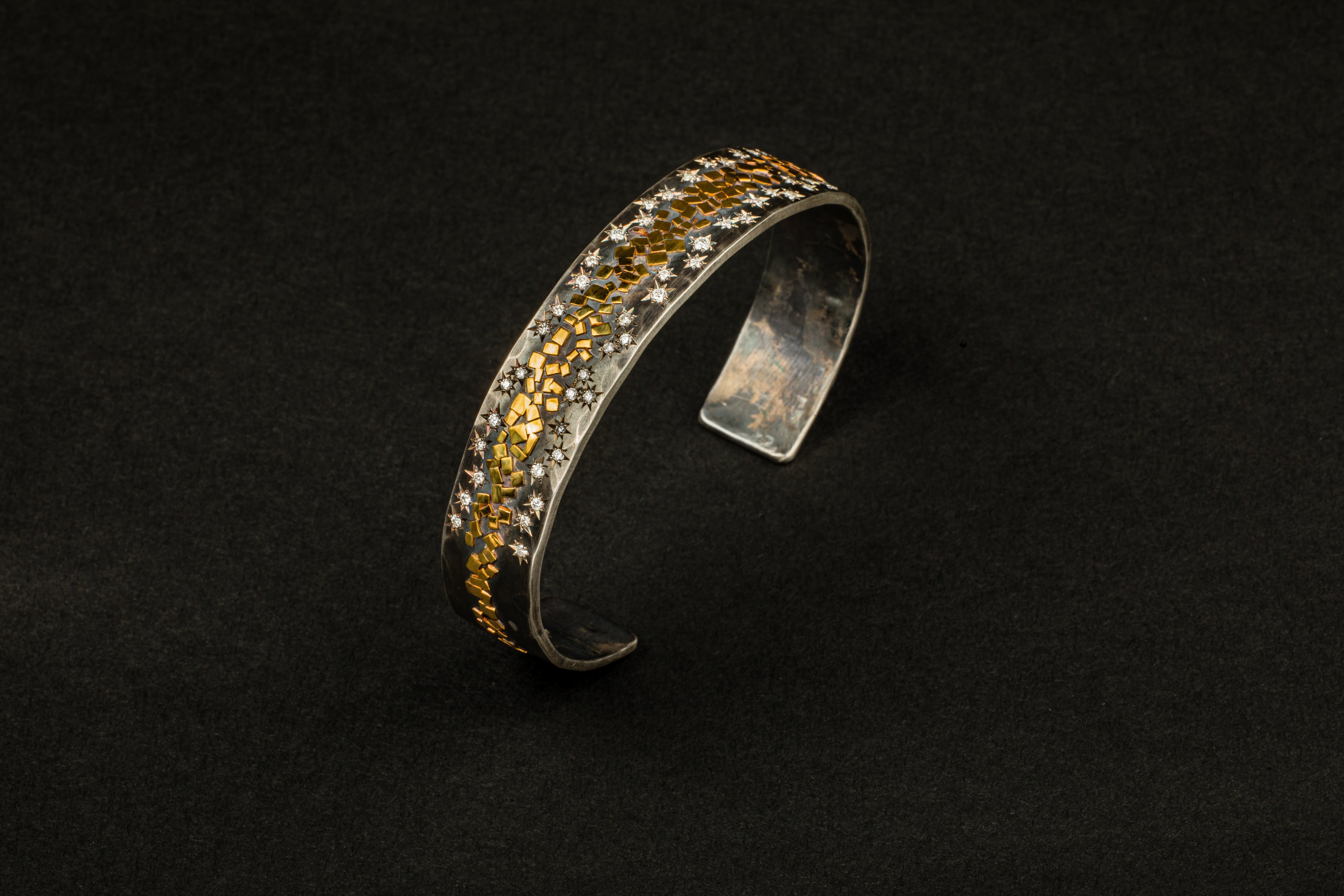 Wide oxidized sterling silver cuff with 22K yellow gold flakes and 24 star-set diamonds