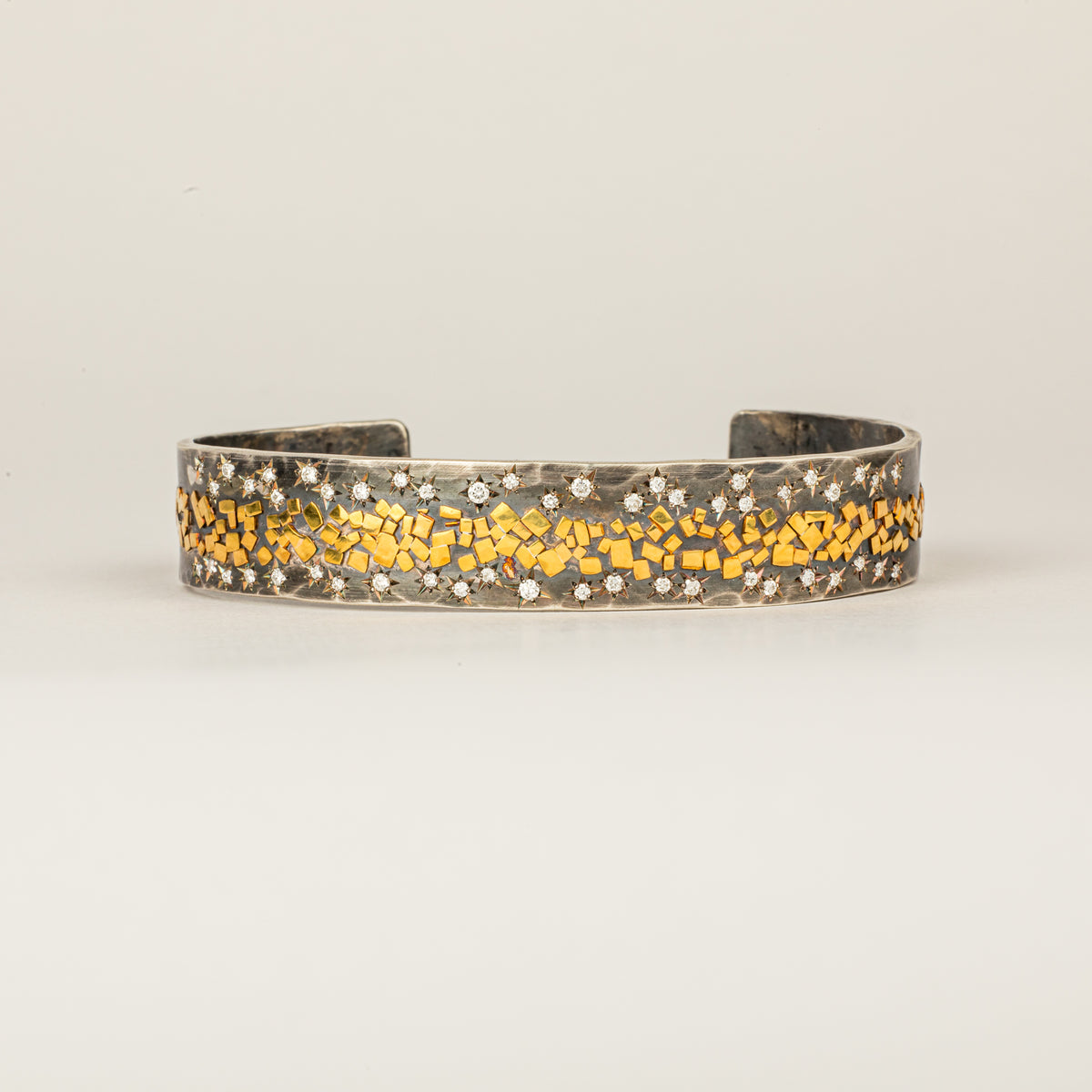 Wide oxidized sterling silver cuff with 22K yellow gold flakes and 24 star-set diamonds