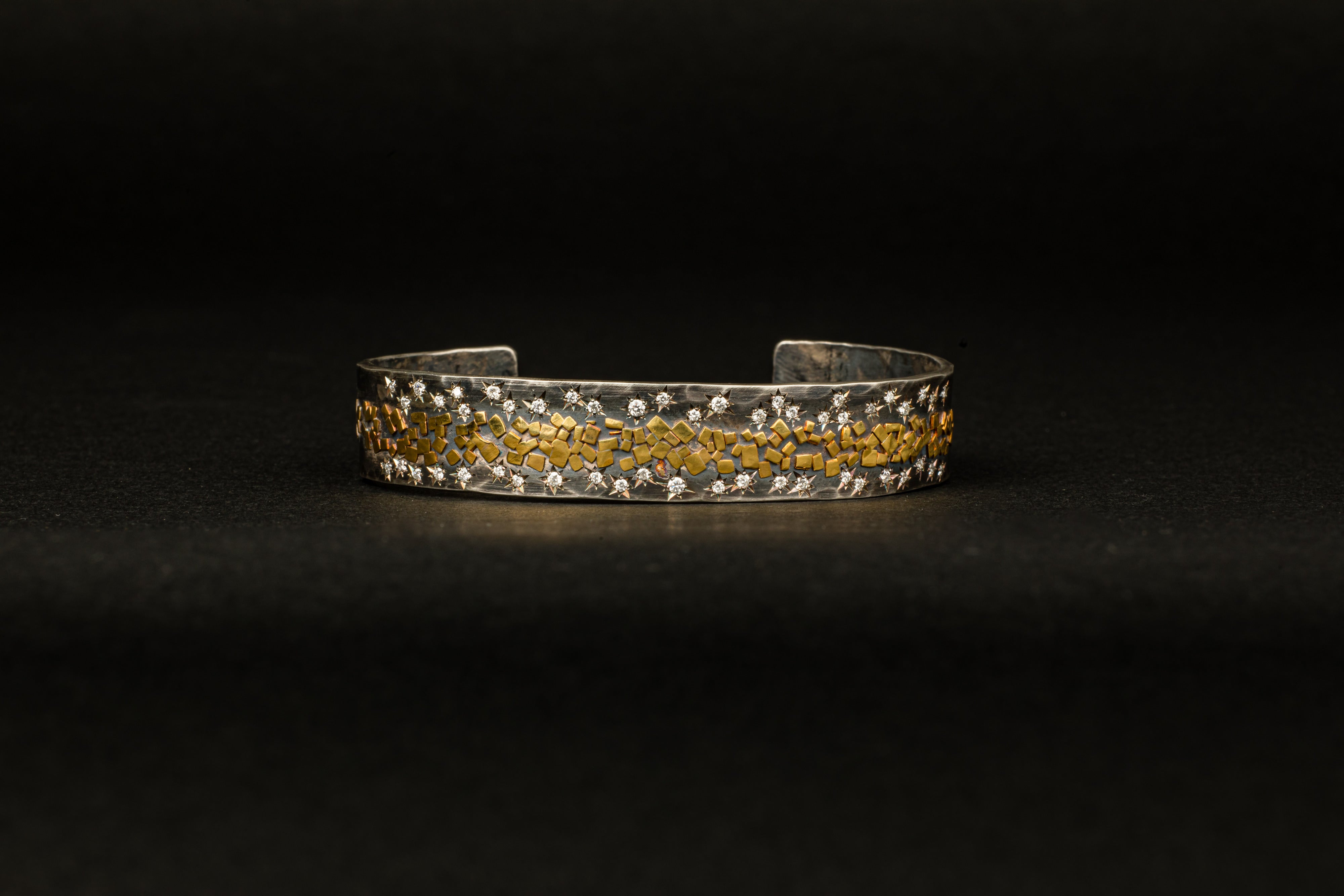 Wide oxidized sterling silver cuff with 22K yellow gold flakes and 24 star-set diamonds