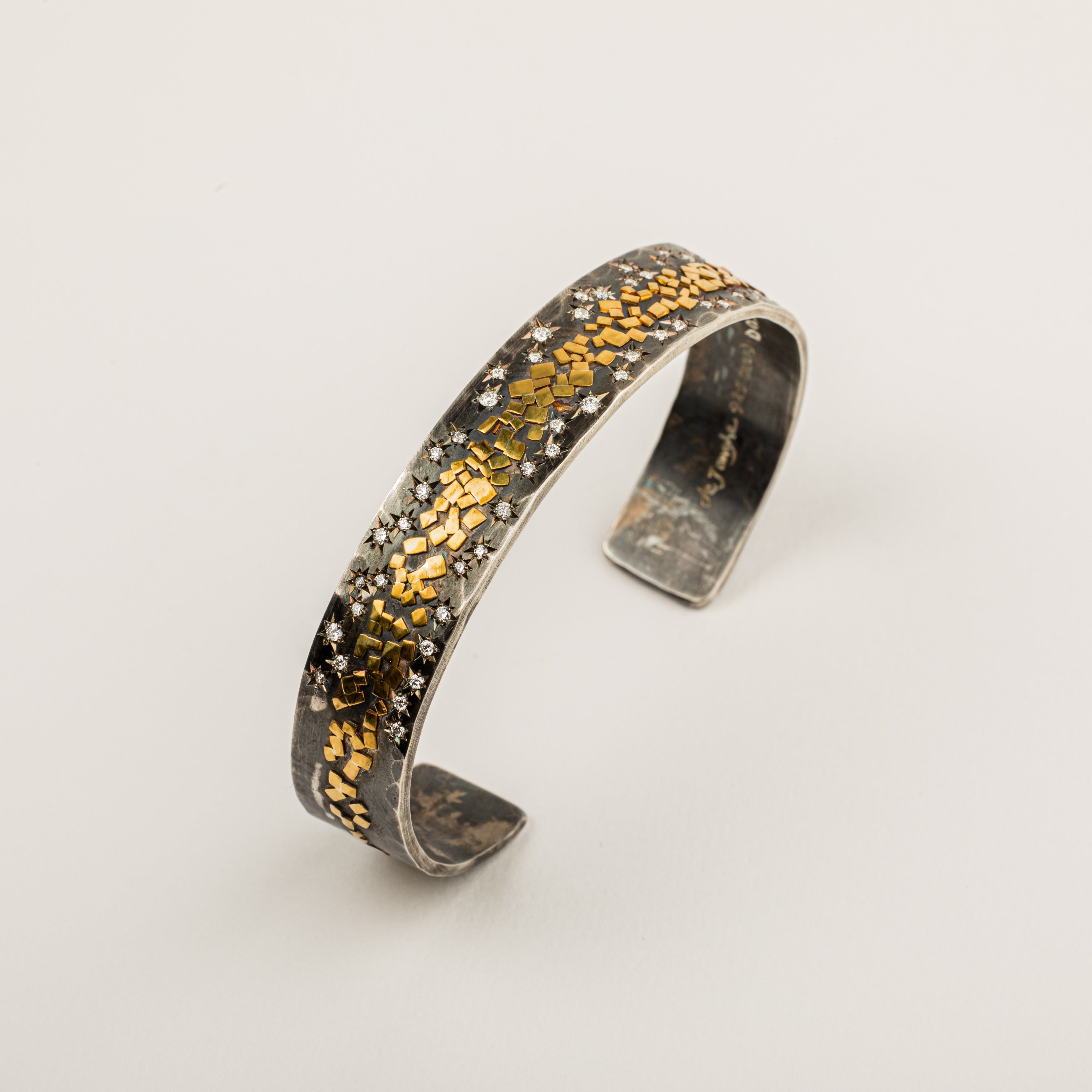 Wide oxidized sterling silver cuff with 22K yellow gold flakes and 24 star-set diamonds