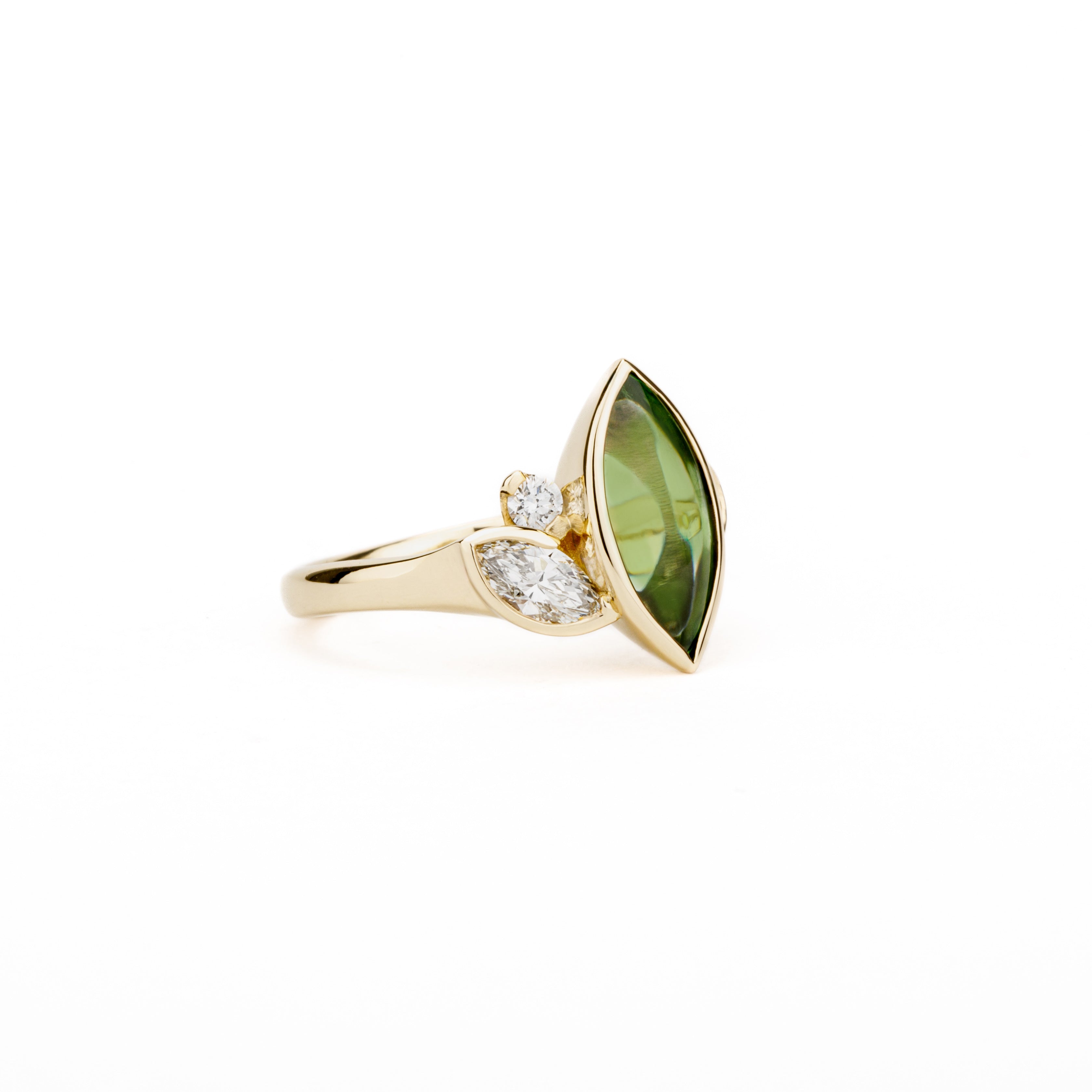 Marquise peridot and diamond ring in 14k yellow gold with bezel setting and asymmetric design