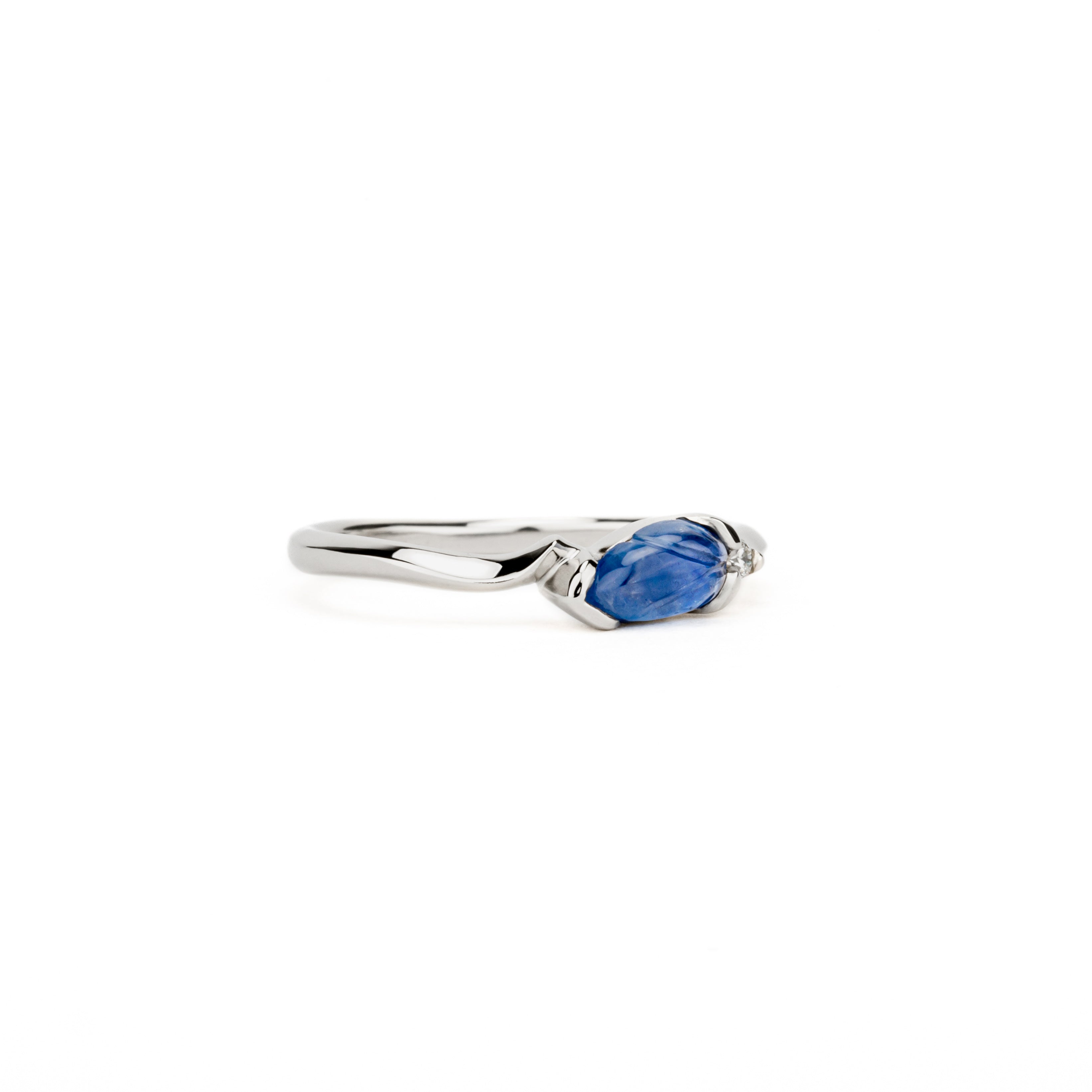 One of a kind carved blue sapphire leaf ring with diamond accent in white gold by deJonghe Jewelry