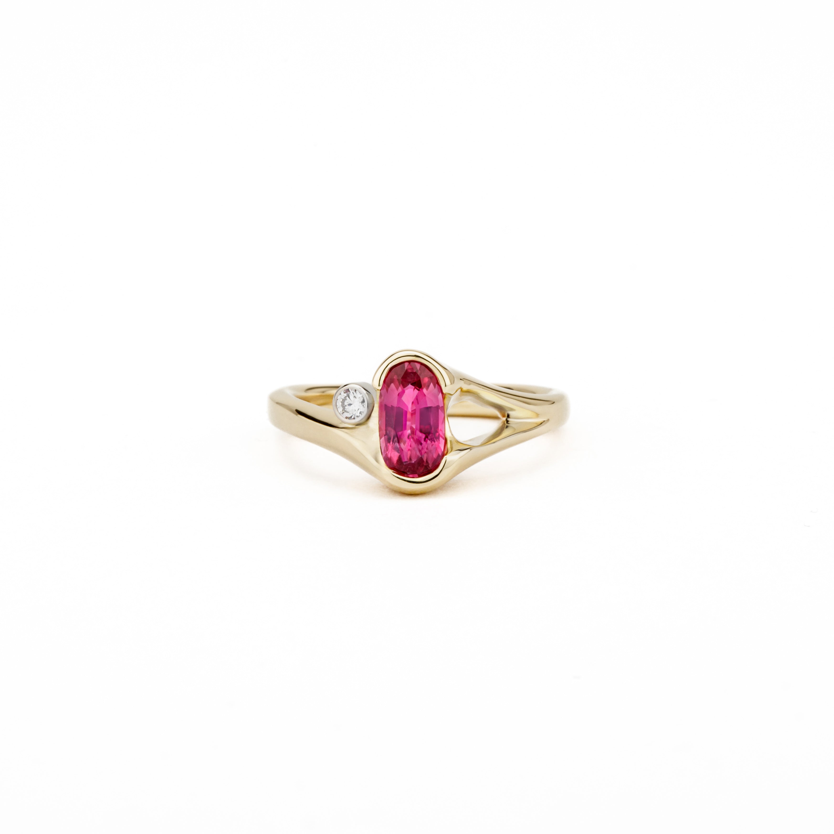 One of a kind oval pink sapphire ring in 14k yellow gold with diamond accent