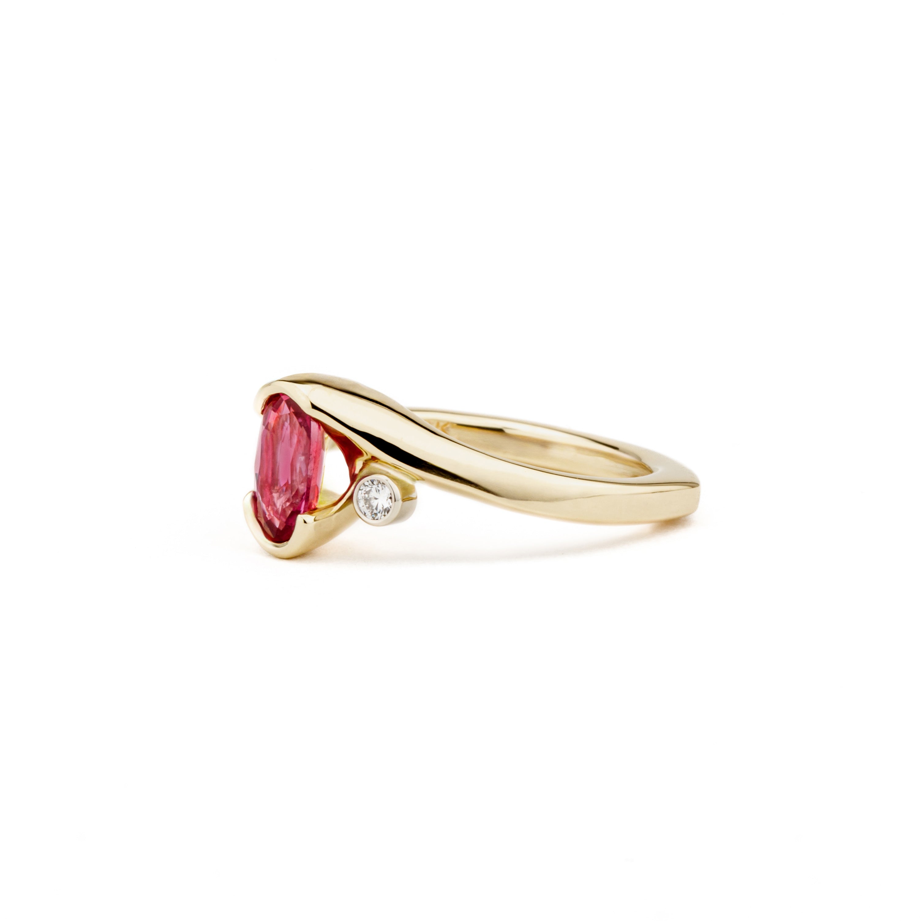 One of a kind oval pink sapphire ring in 14k yellow gold with diamond accent