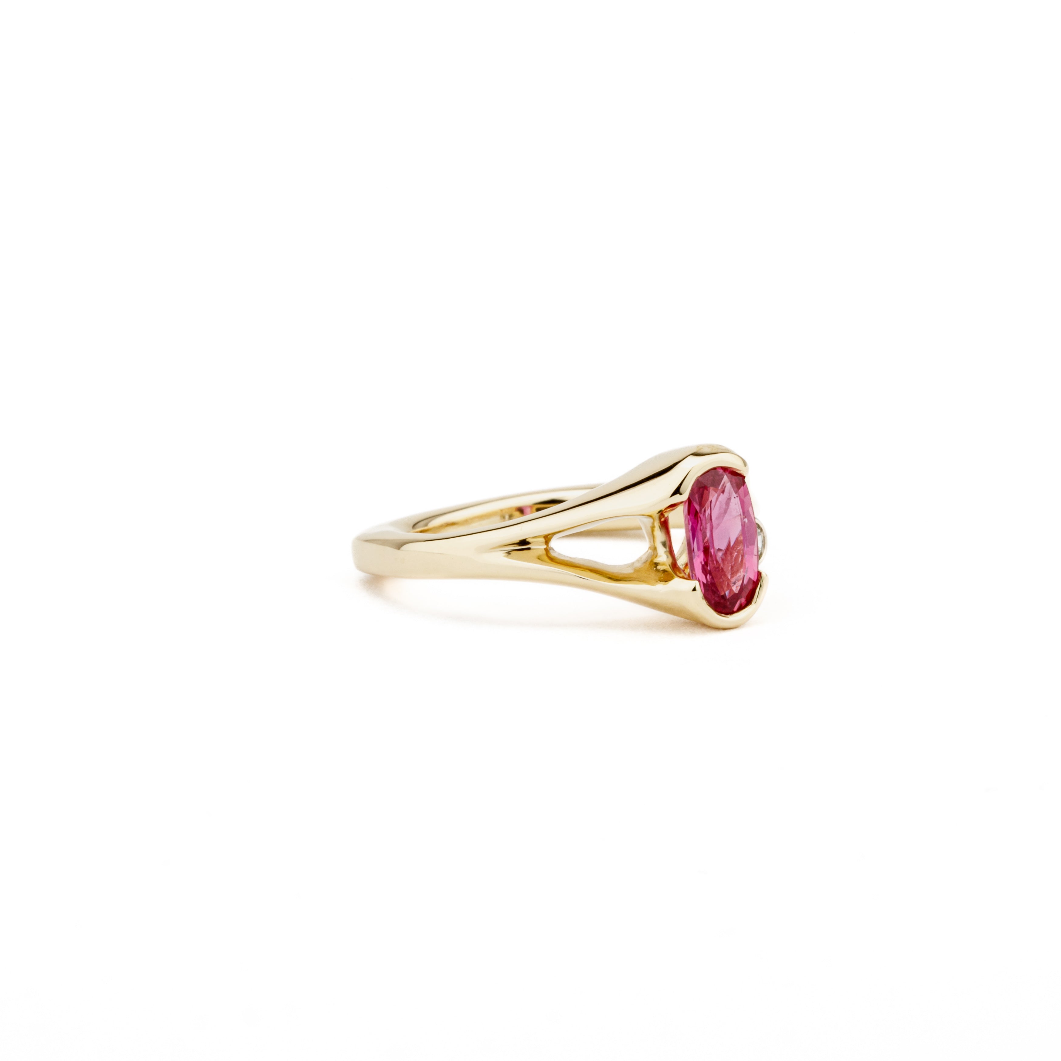 One of a kind oval pink sapphire ring in 14k yellow gold with diamond accent