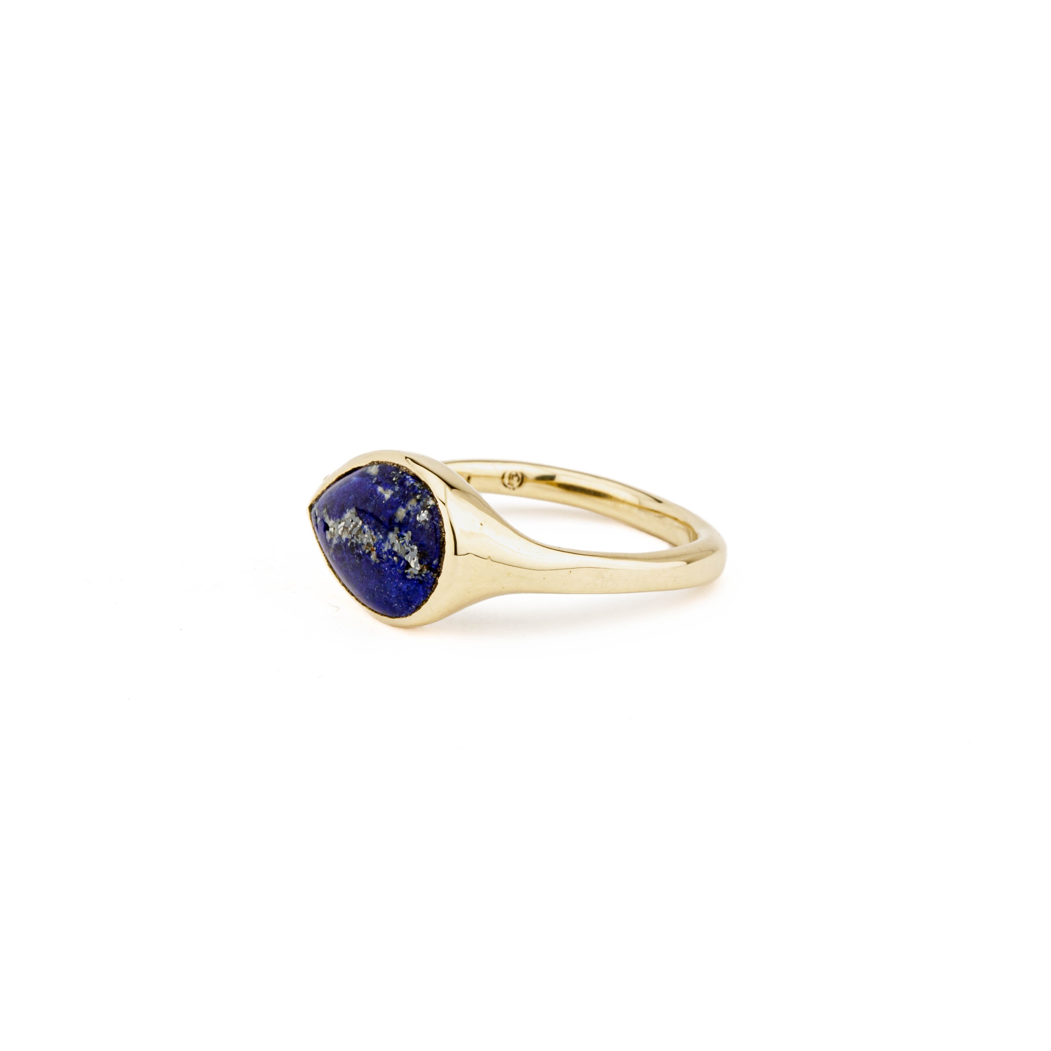 Yellow gold ring with a sideways pear-shaped lapis lazuli cabochon and a single round diamond accent.