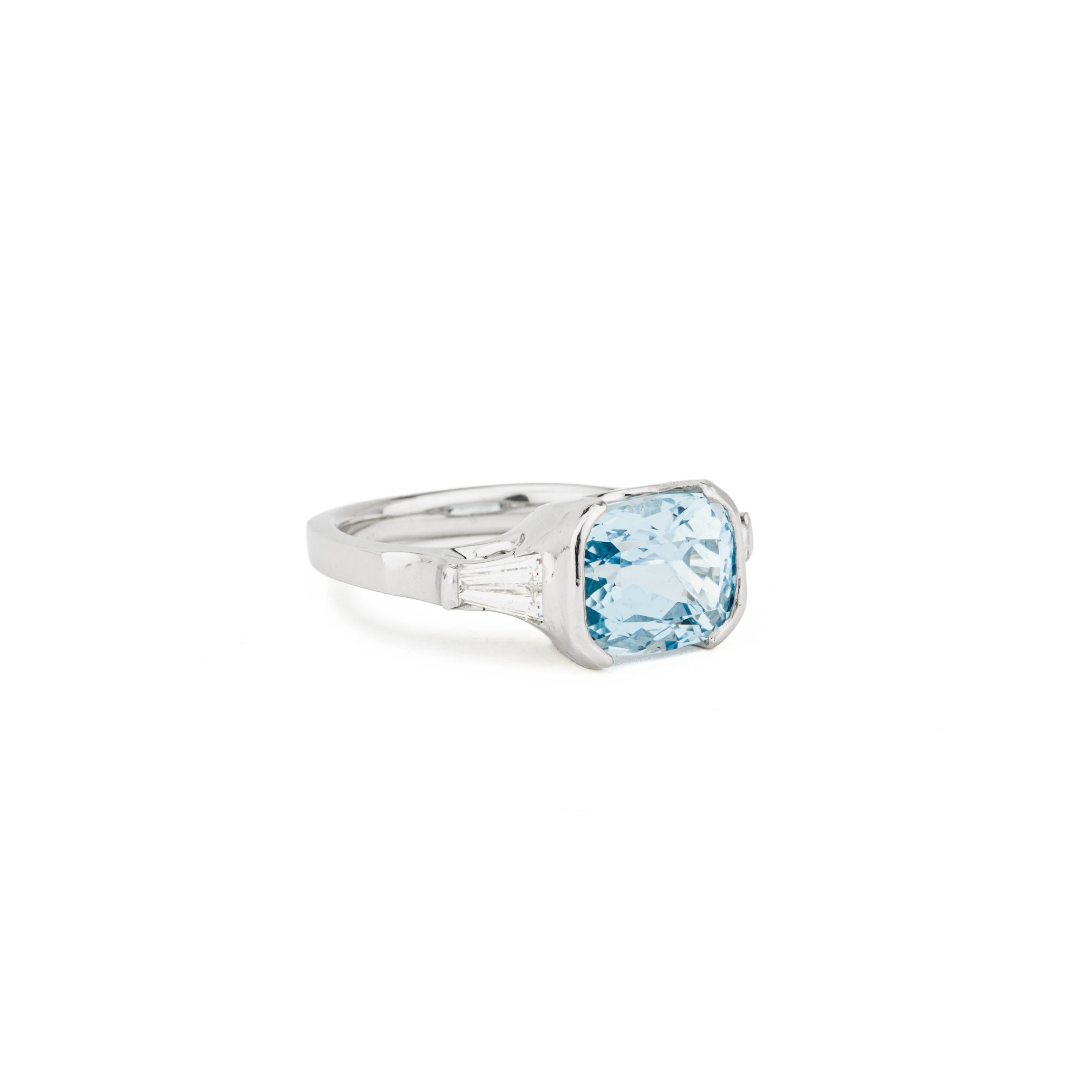 Platinum ring with a cushion cut aquamarine center stone and tapered baguette diamond accents, size 7.5