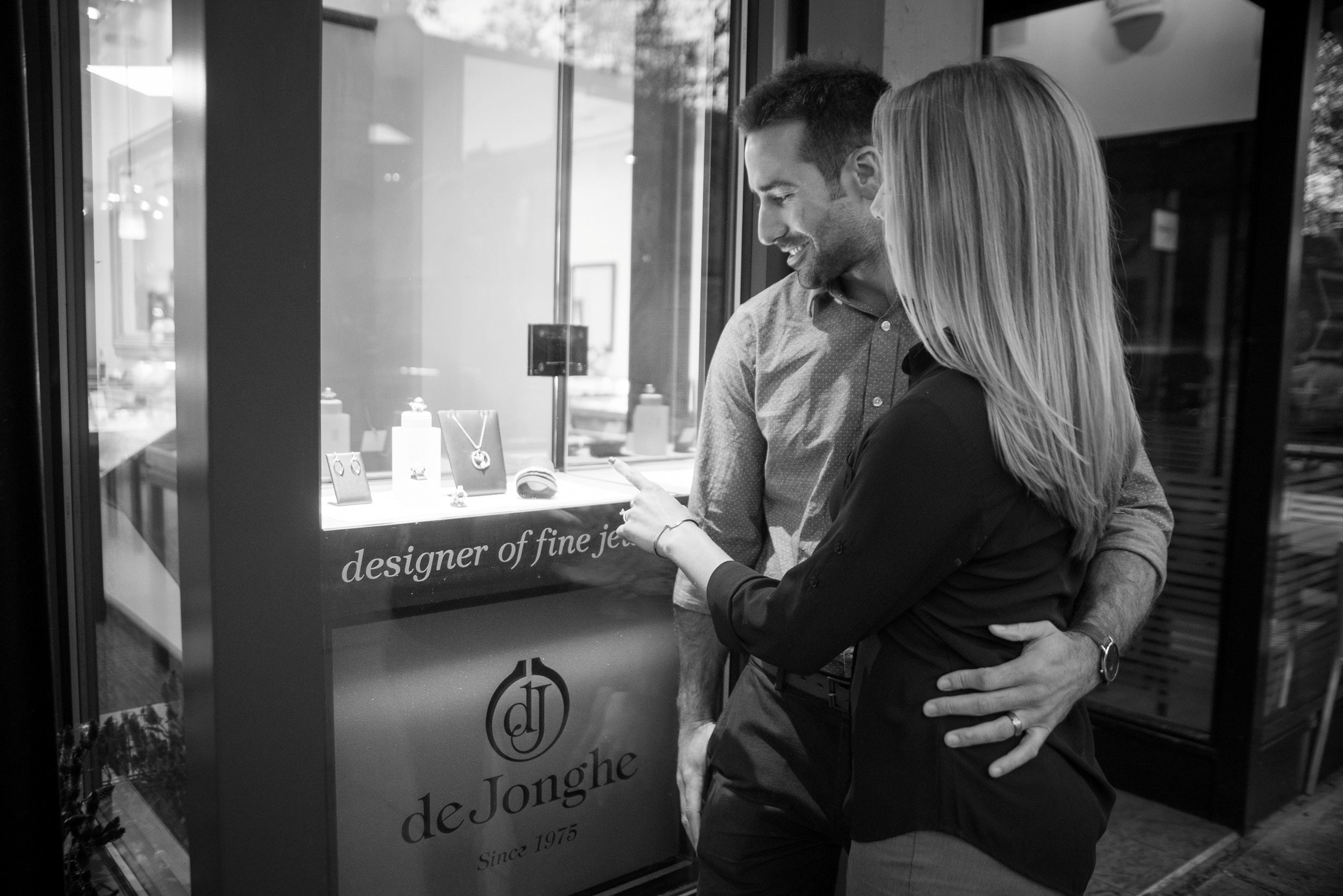 Man and woman looking at jewelry display inside deJonghe Original Jewelry