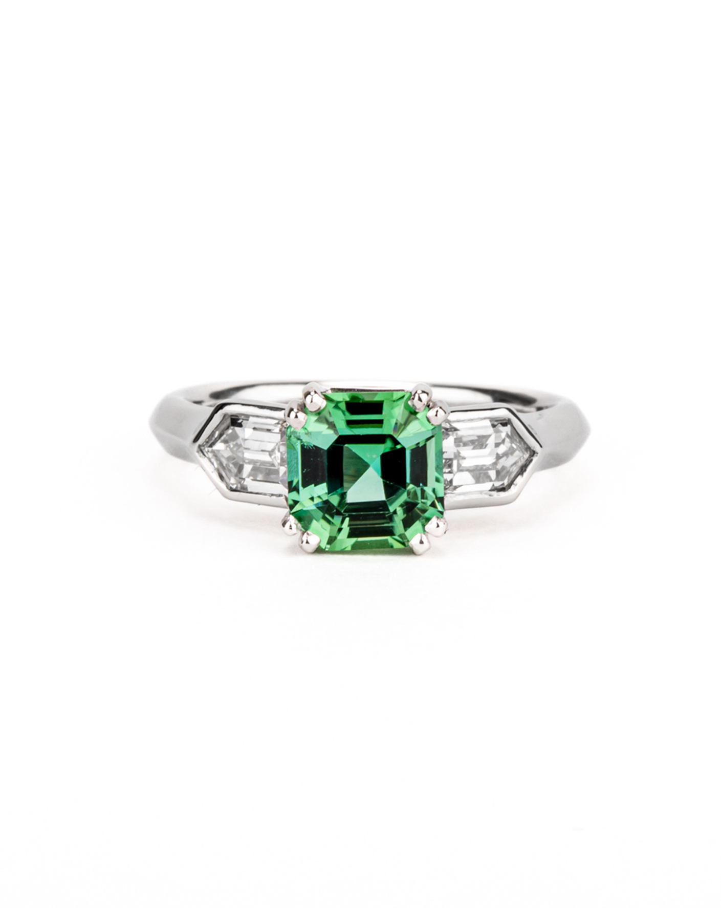 Platinum three-stone ring featuring a 1.77ct asscher-cut seafoam green tourmaline flanked by bullet-shaped diamond shoulders