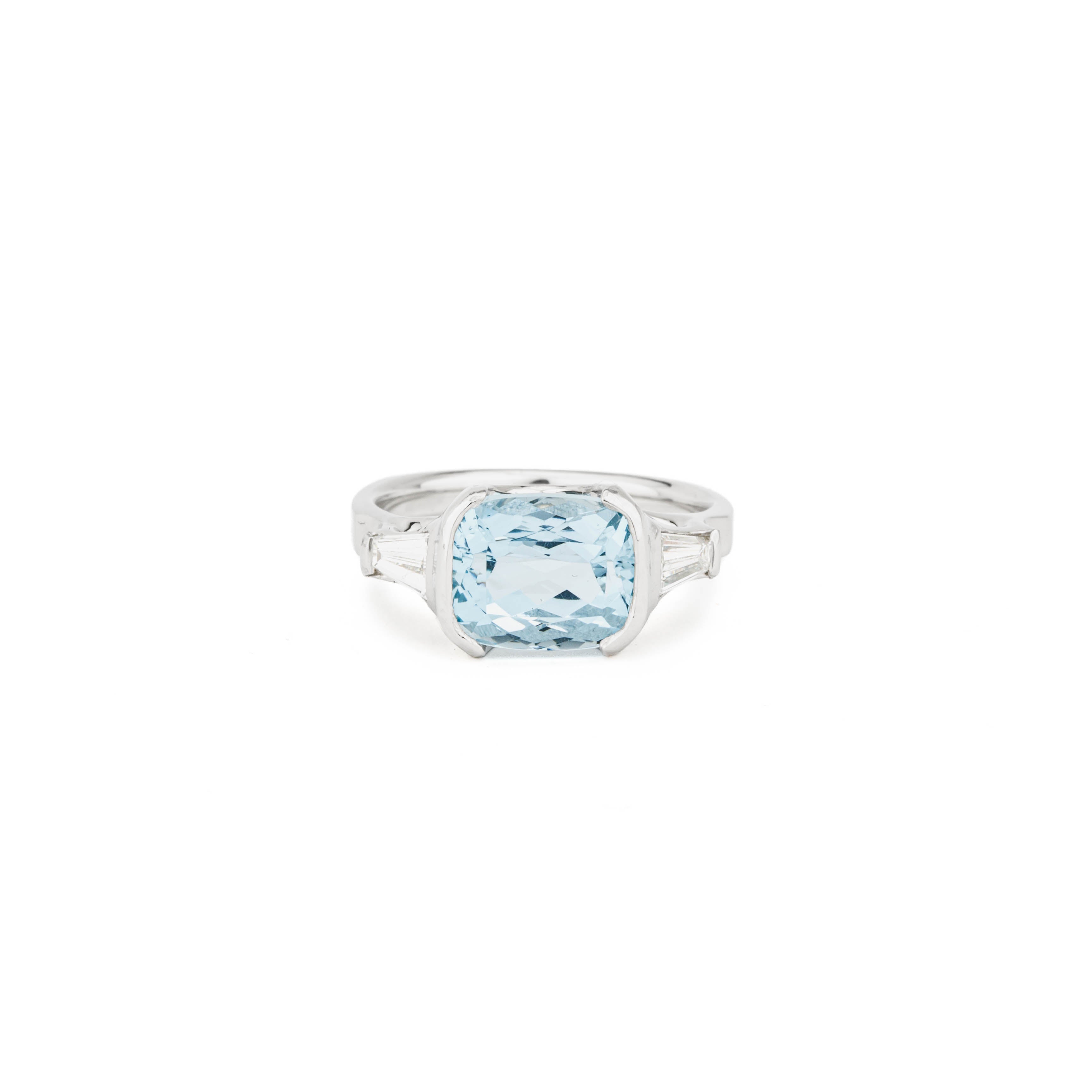 Platinum ring with a cushion cut aquamarine center stone and tapered baguette diamond accents, size 7.5