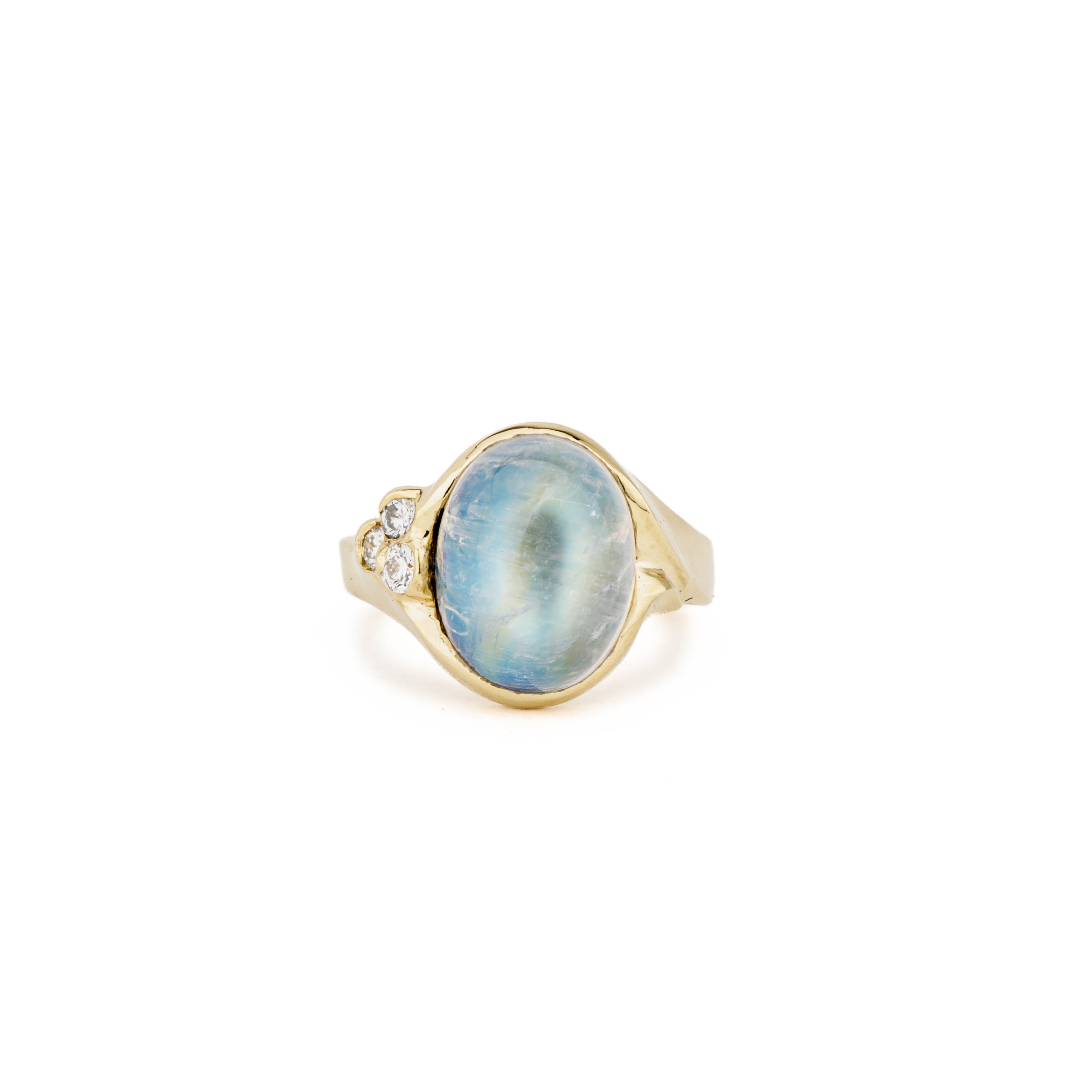 14k yellow gold ring with 7.22ct oval cabochon moonstone in bezel setting and cluster of three round diamonds, size 7