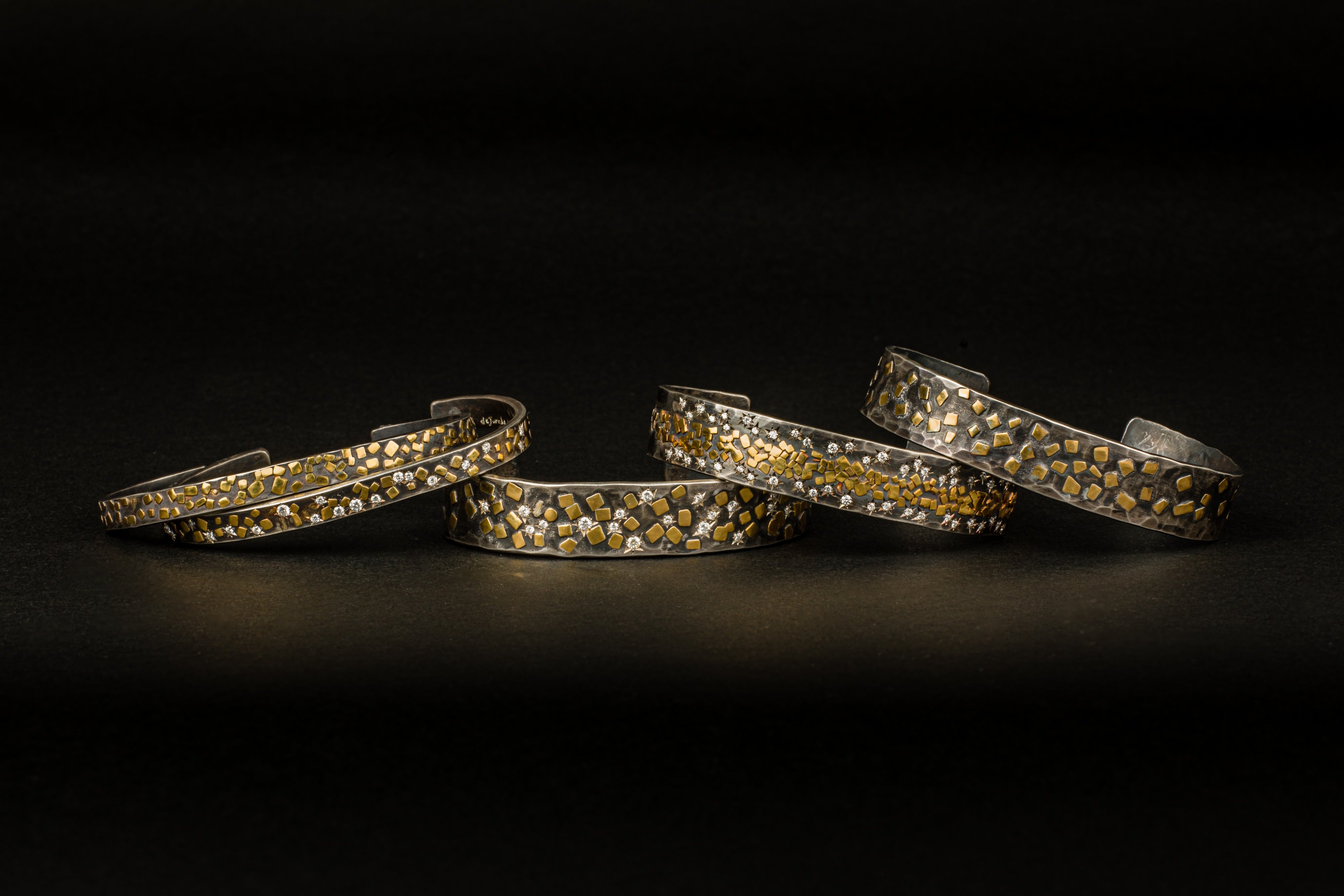 Oxidized sterling silver cuff bracelets with gold flakes and diamonds