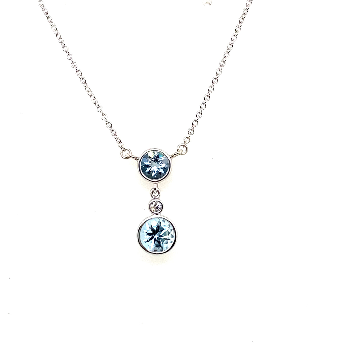 White gold necklace with two round bezel-set aquamarines and a small bezel-set diamond on a split chain