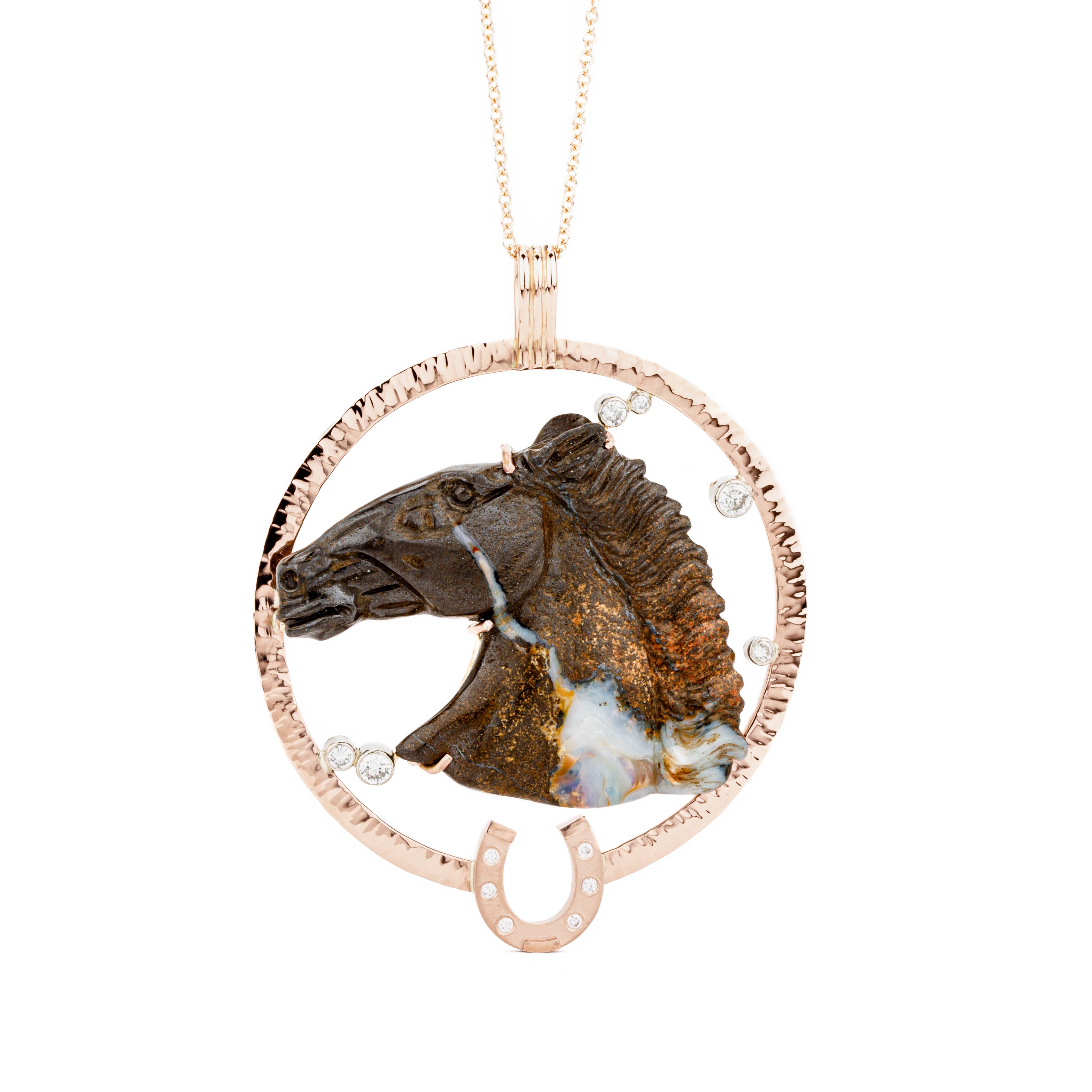 Custom one-of-a-kind pendant featuring a hand-carved Australian boulder opal horse head in 18k yellow gold prongs, set in a hammered 14k rose gold circle frame with a diamond-set horseshoe and floating diamond accents