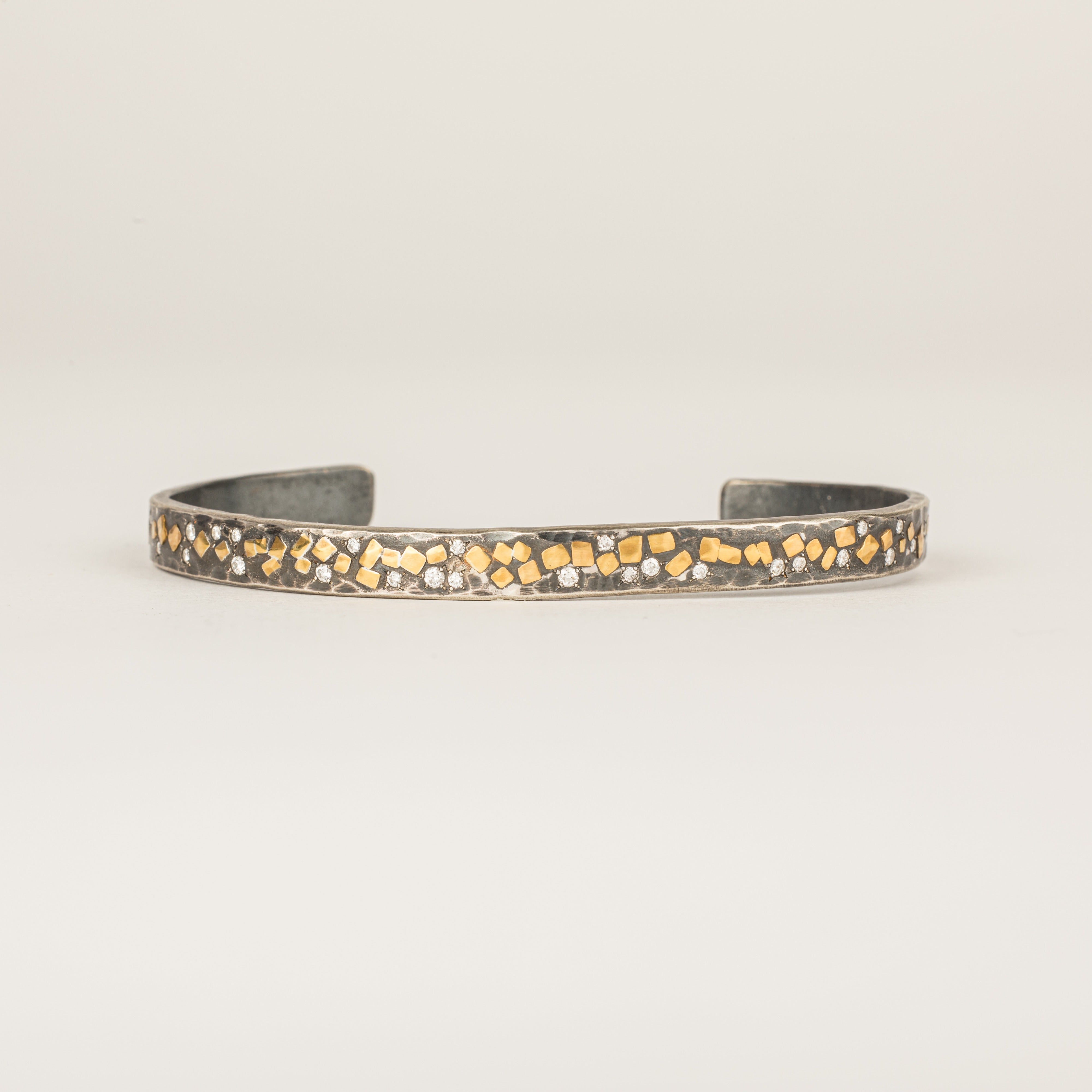 Oxidized sterling silver cuff bracelet with 22k yellow gold flake accents and diamond star settings