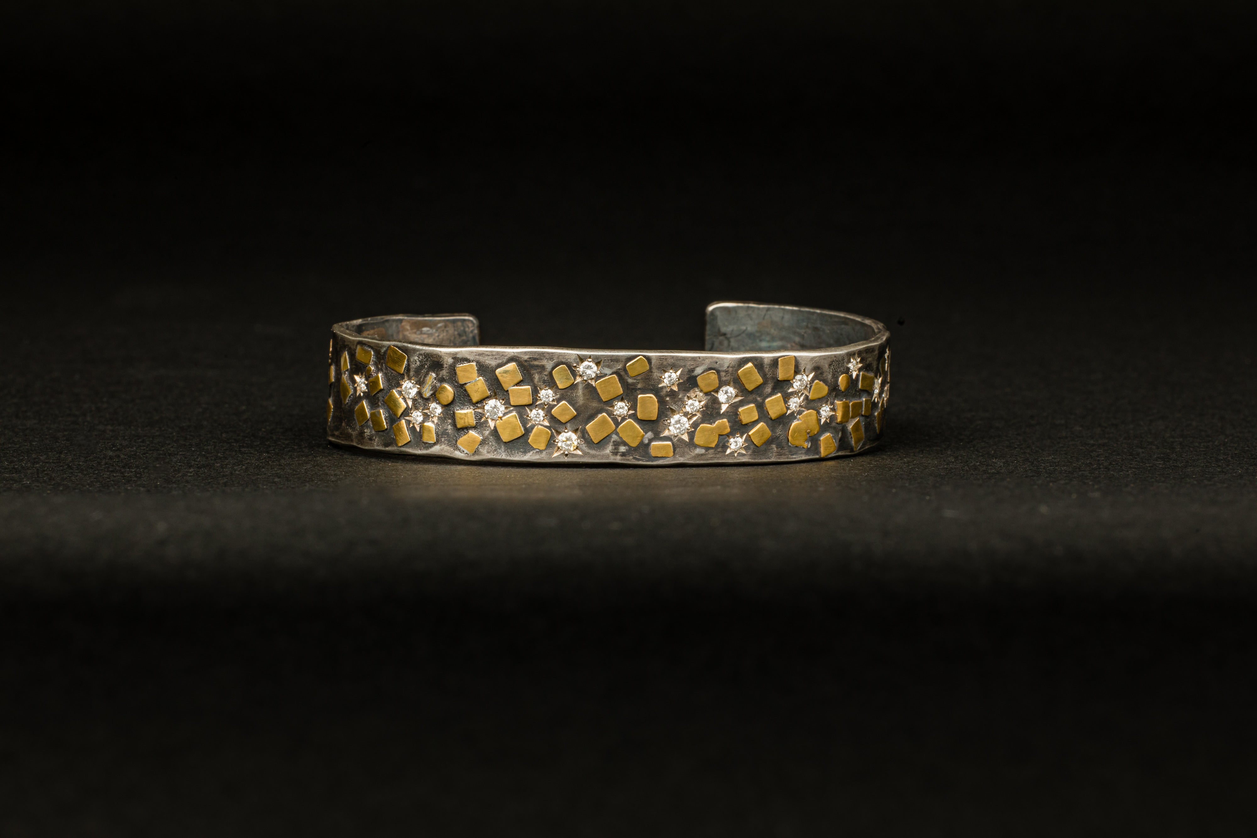 Oxidized sterling silver cuff bracelet with scattered 22K yellow gold flake accents and 24 star-set diamonds