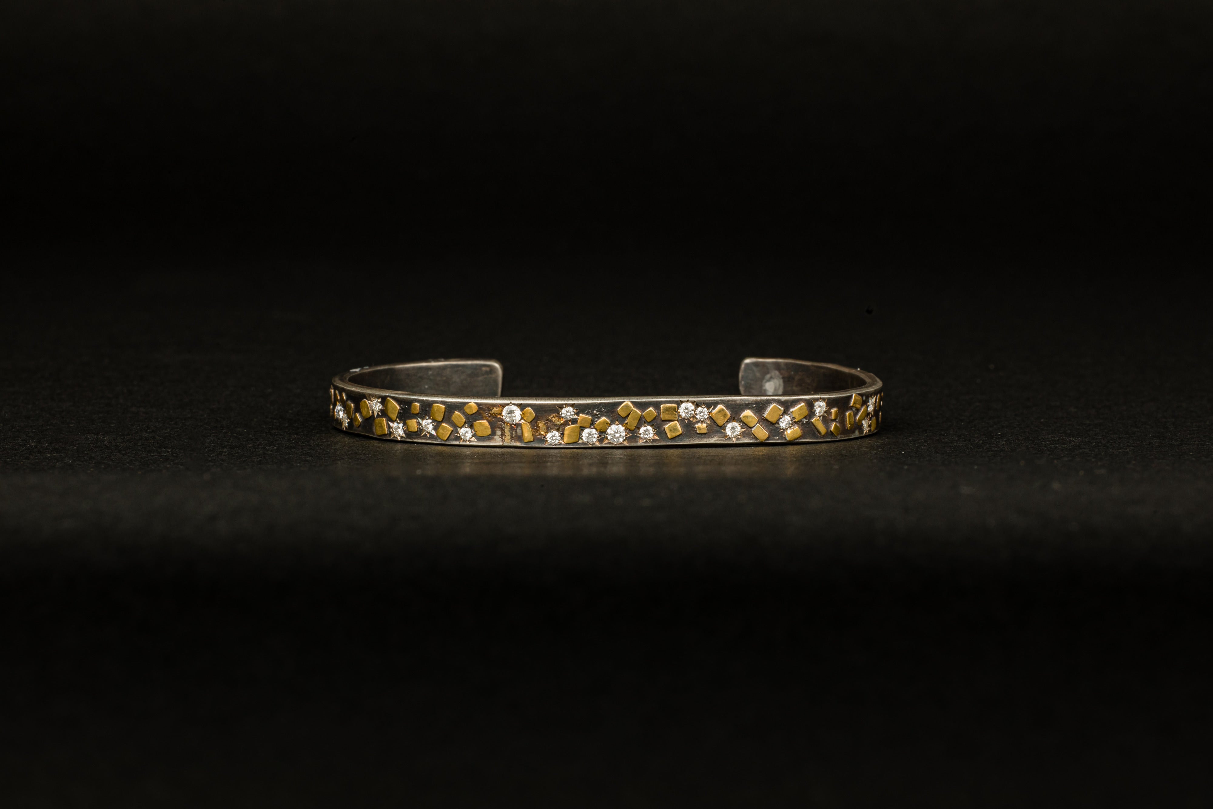 Oxidized sterling silver cuff bracelet with 22k yellow gold flake accents and diamond star settings