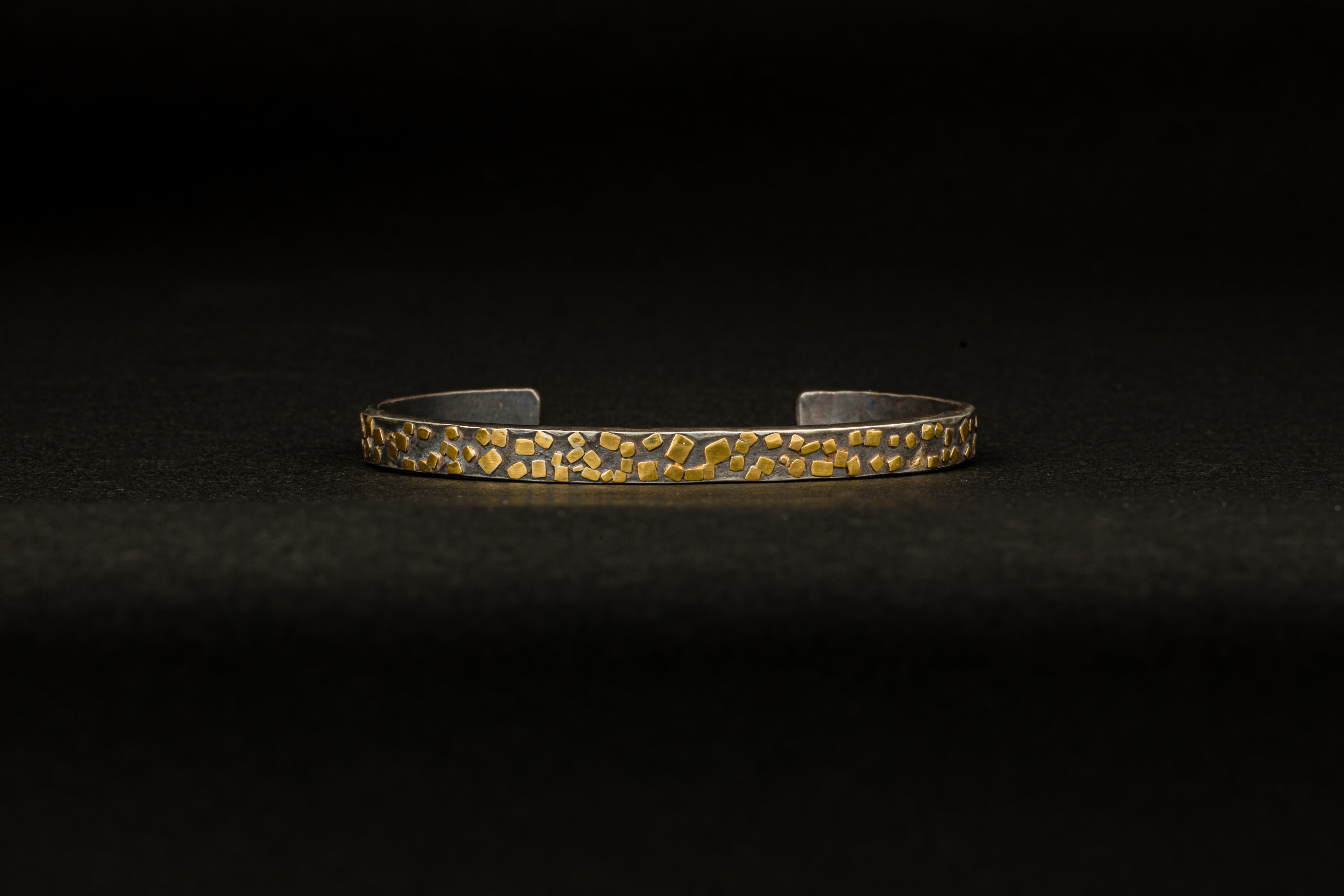 Oxidized sterling silver cuff bracelet with scattered 22k yellow gold flake accents