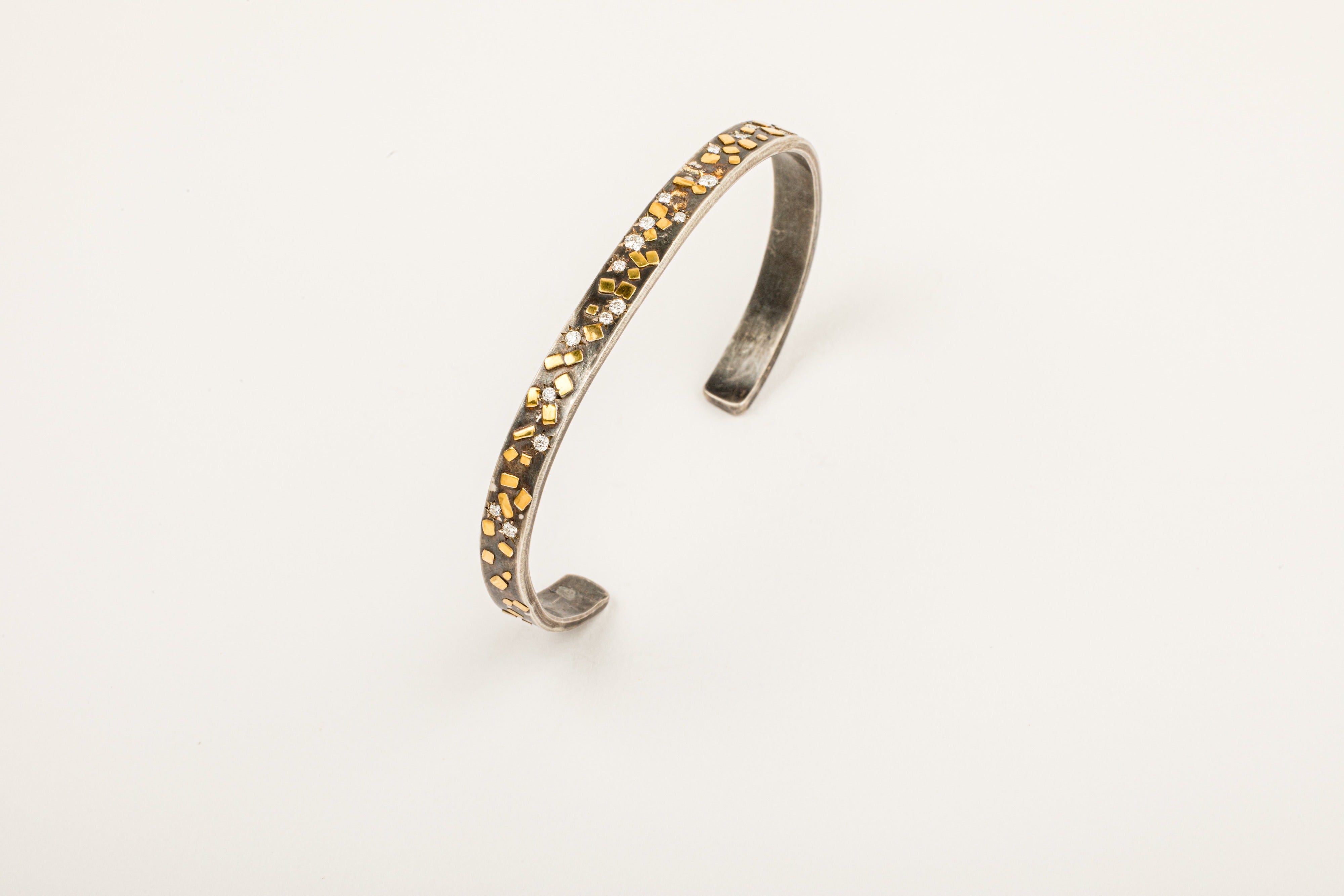 Oxidized sterling silver cuff bracelet with 22k yellow gold flake accents and diamond star settings