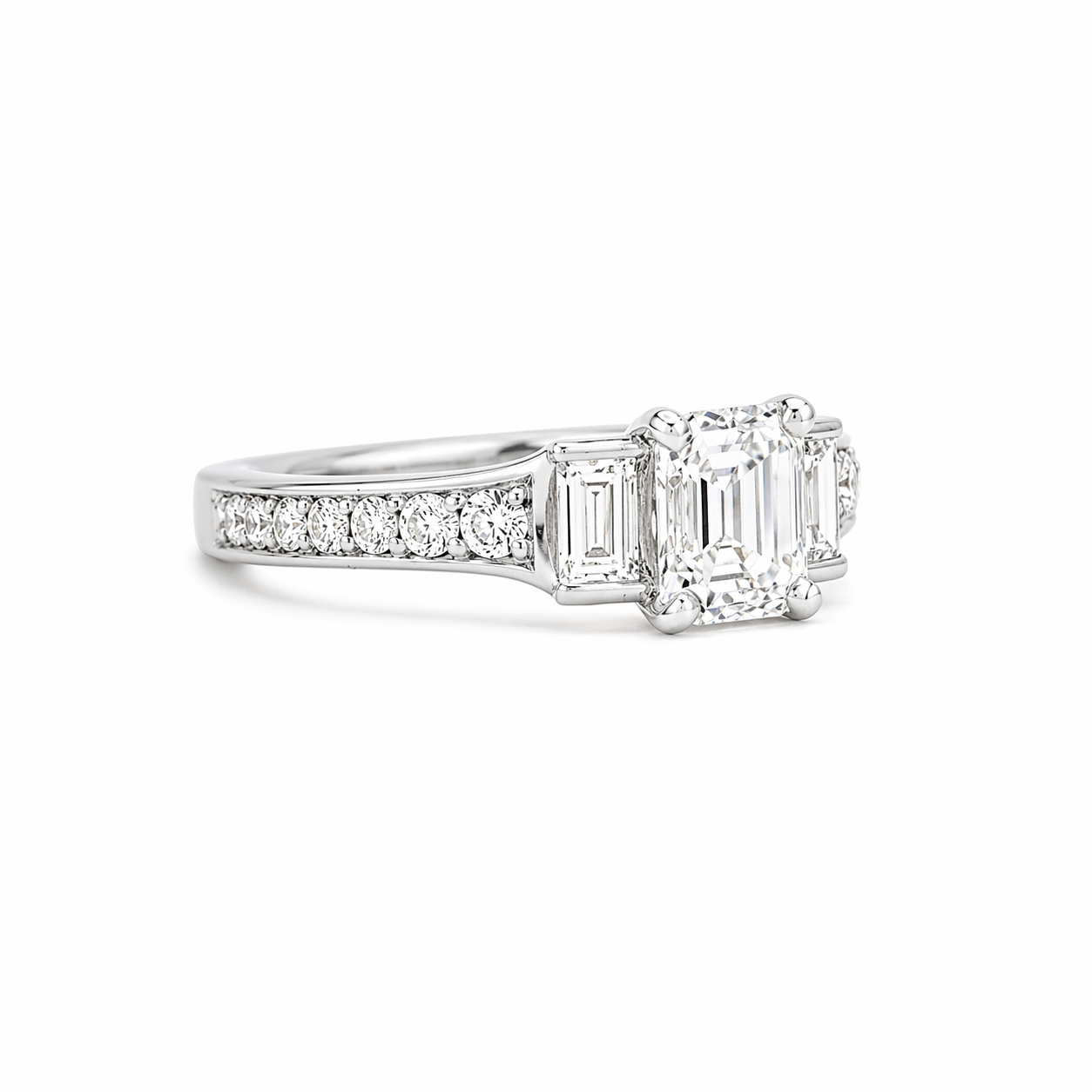 Emerald cut diamond engagement ring with baguette diamond accents and round pave set diamonds. deJonghe Original Jewelry