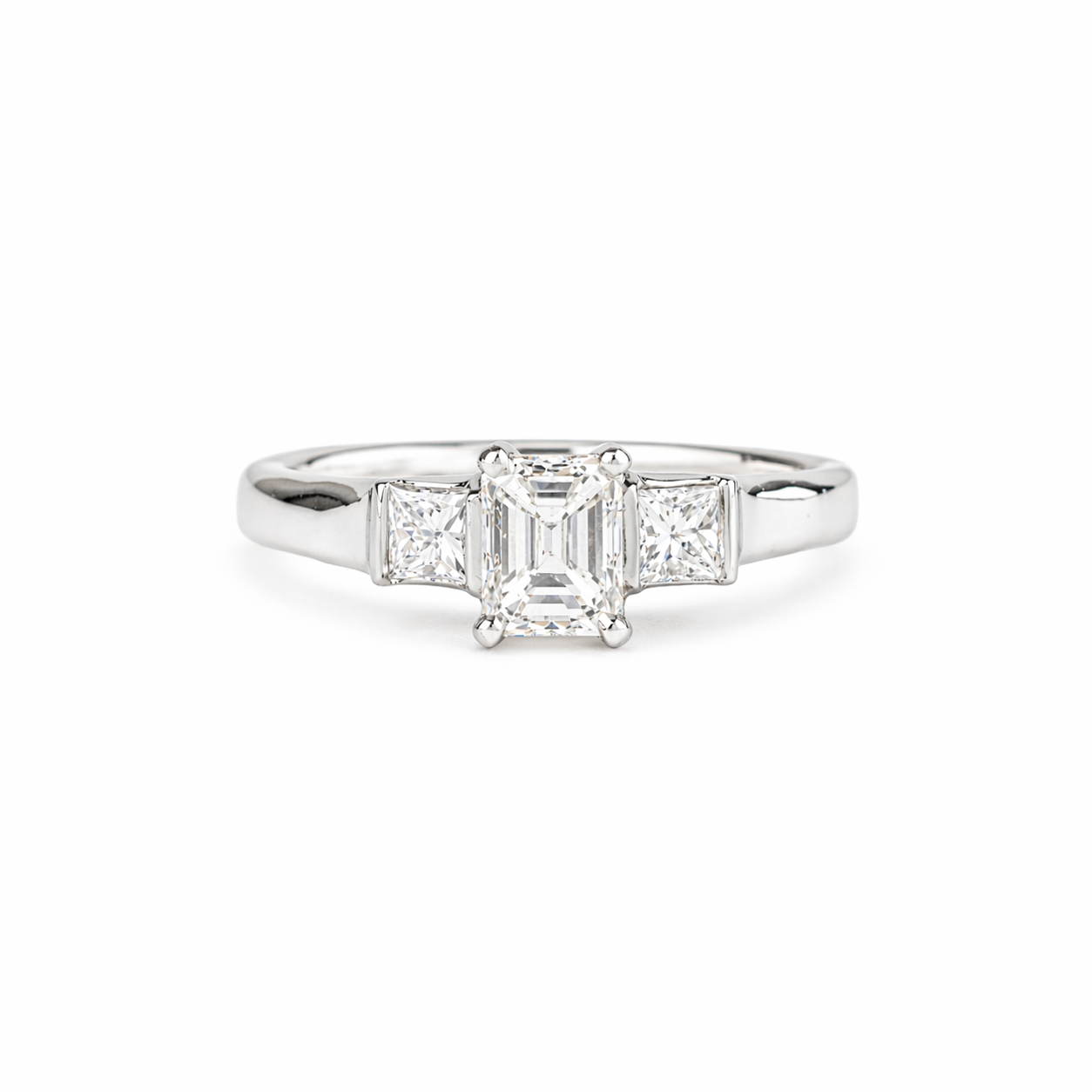  Emerald cut diamond ring with princess cut side stones in platinum