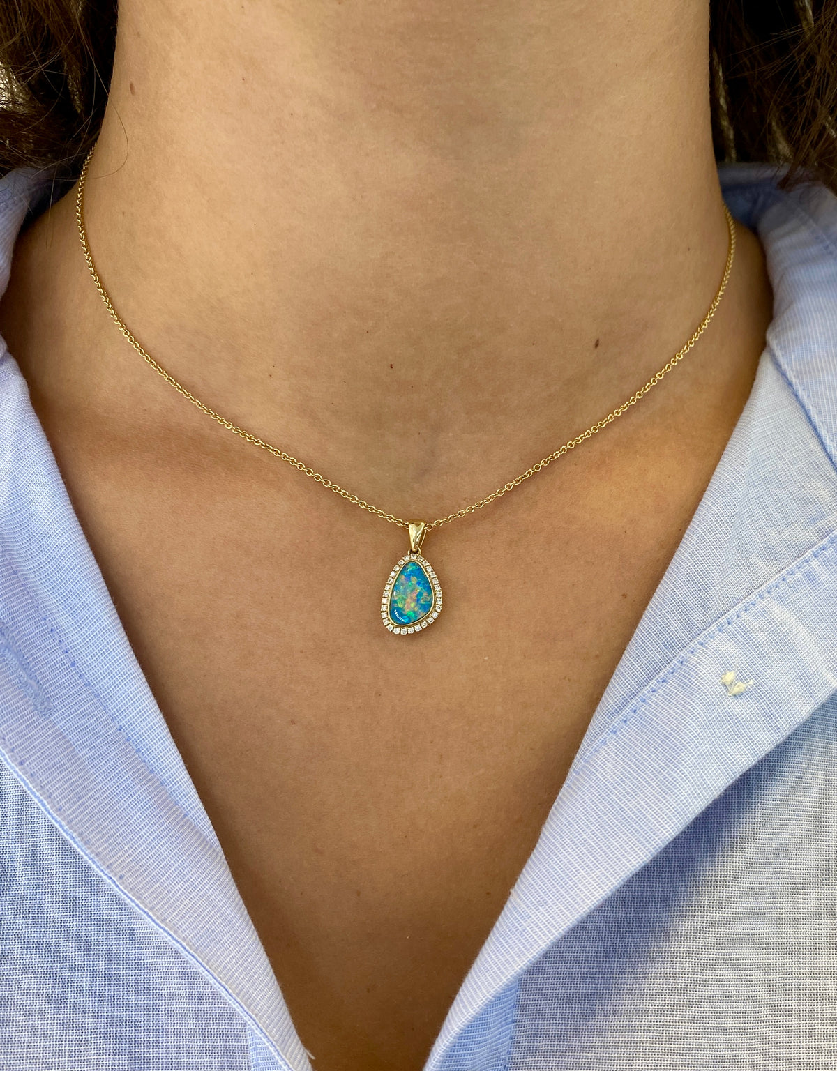  14k yellow gold pendant necklace featuring a freeform opal doublet with pavé diamond halo