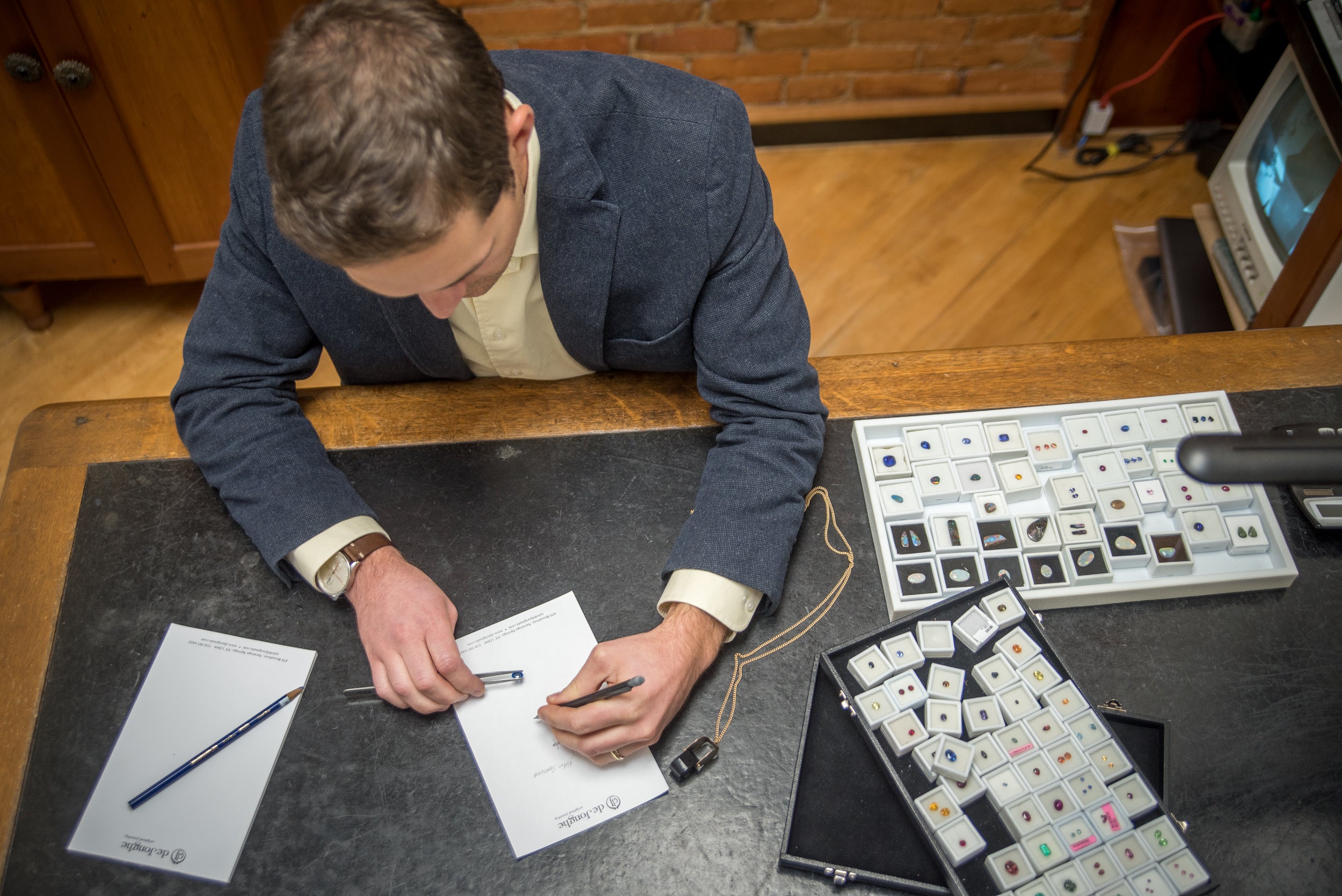 Jeweler taking notes on a gemstone for an appraisal