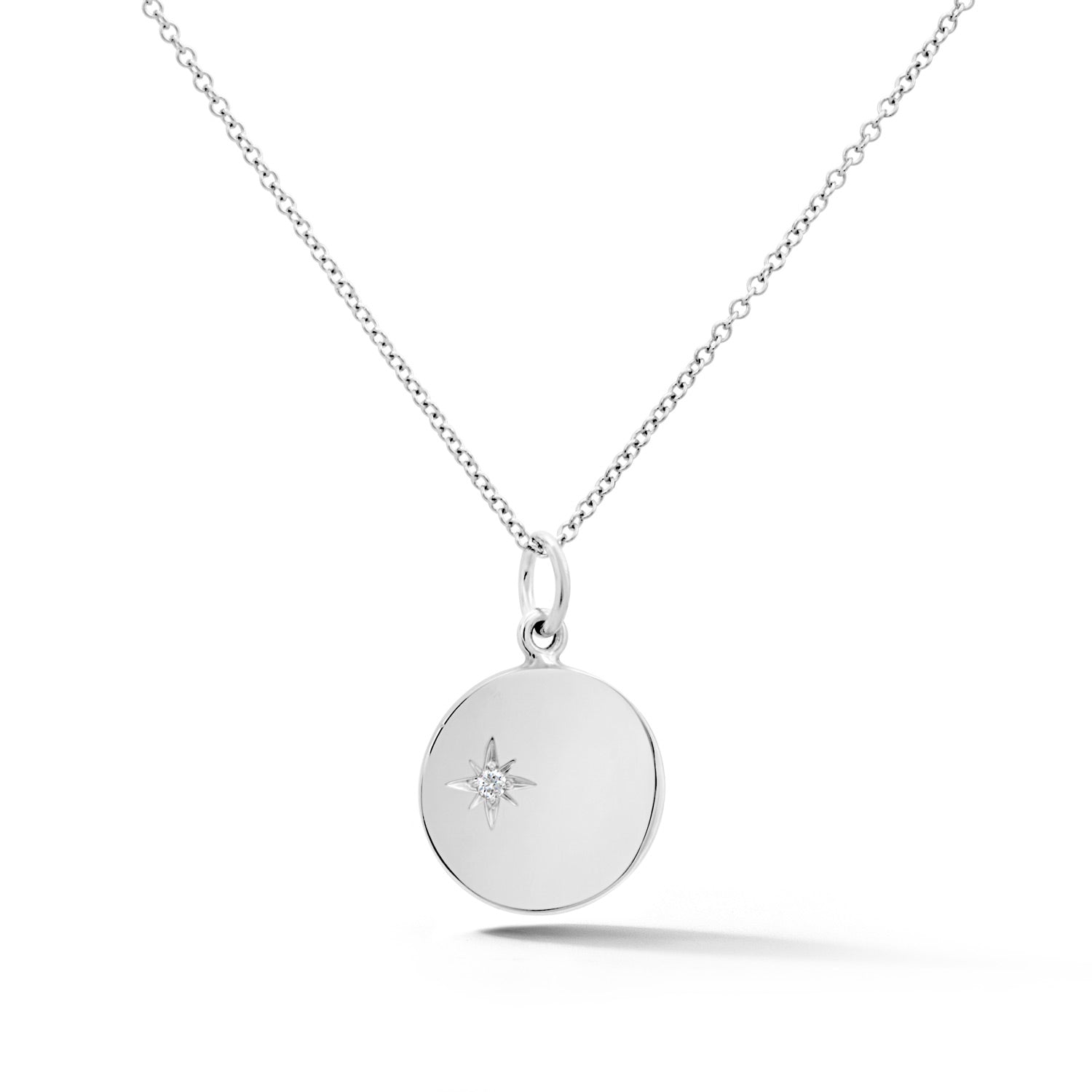 14k white gold circular disc pendant with diamond starburst center