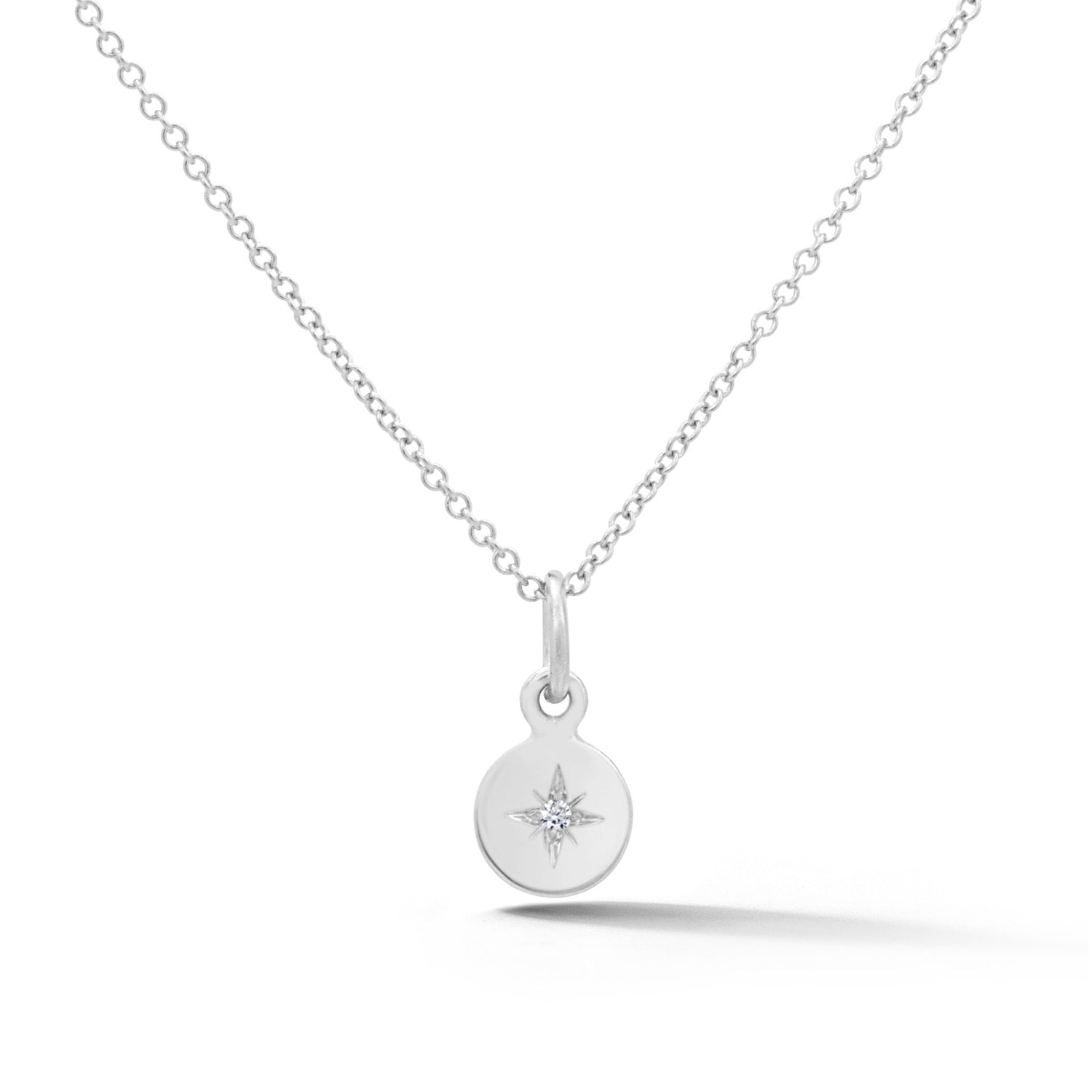 14k white gold disc pendant with diamond starburst design