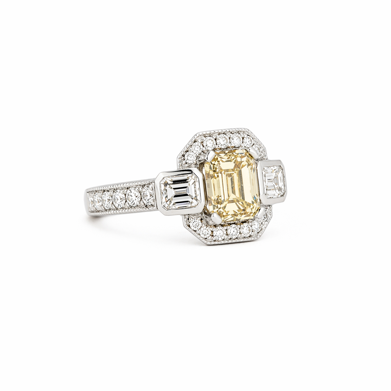 Platinum ring with emerald-cut champagne diamond, geometric halo, and diamond pavé band