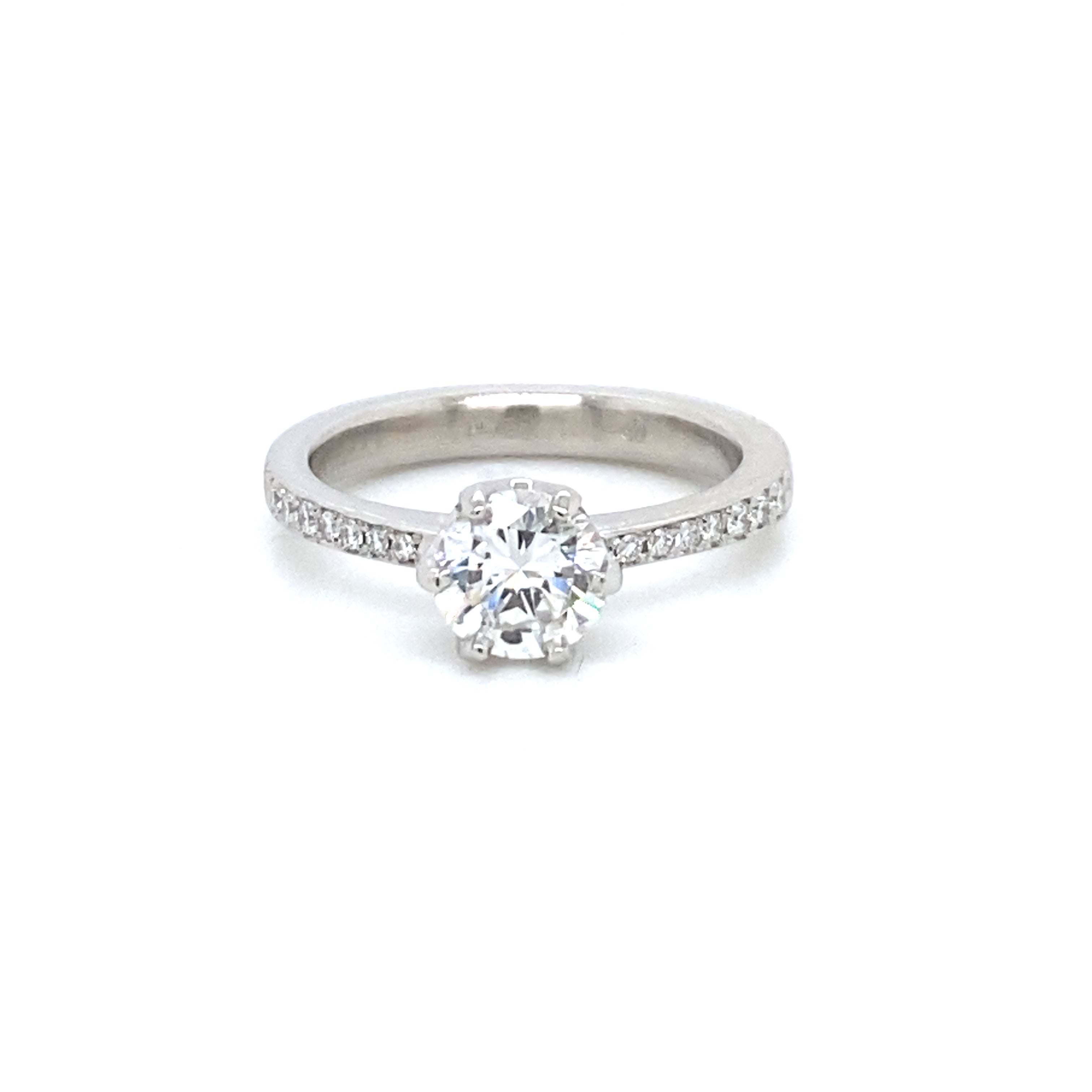  Round diamond engagement ring with pavé diamond shoulders and six prong platinum 
