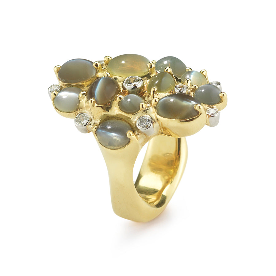 One-of-a-kind 18K yellow gold cluster ring featuring twelve cat's eye chrysoberyl cabochons with platinum bezel-set diamond accents