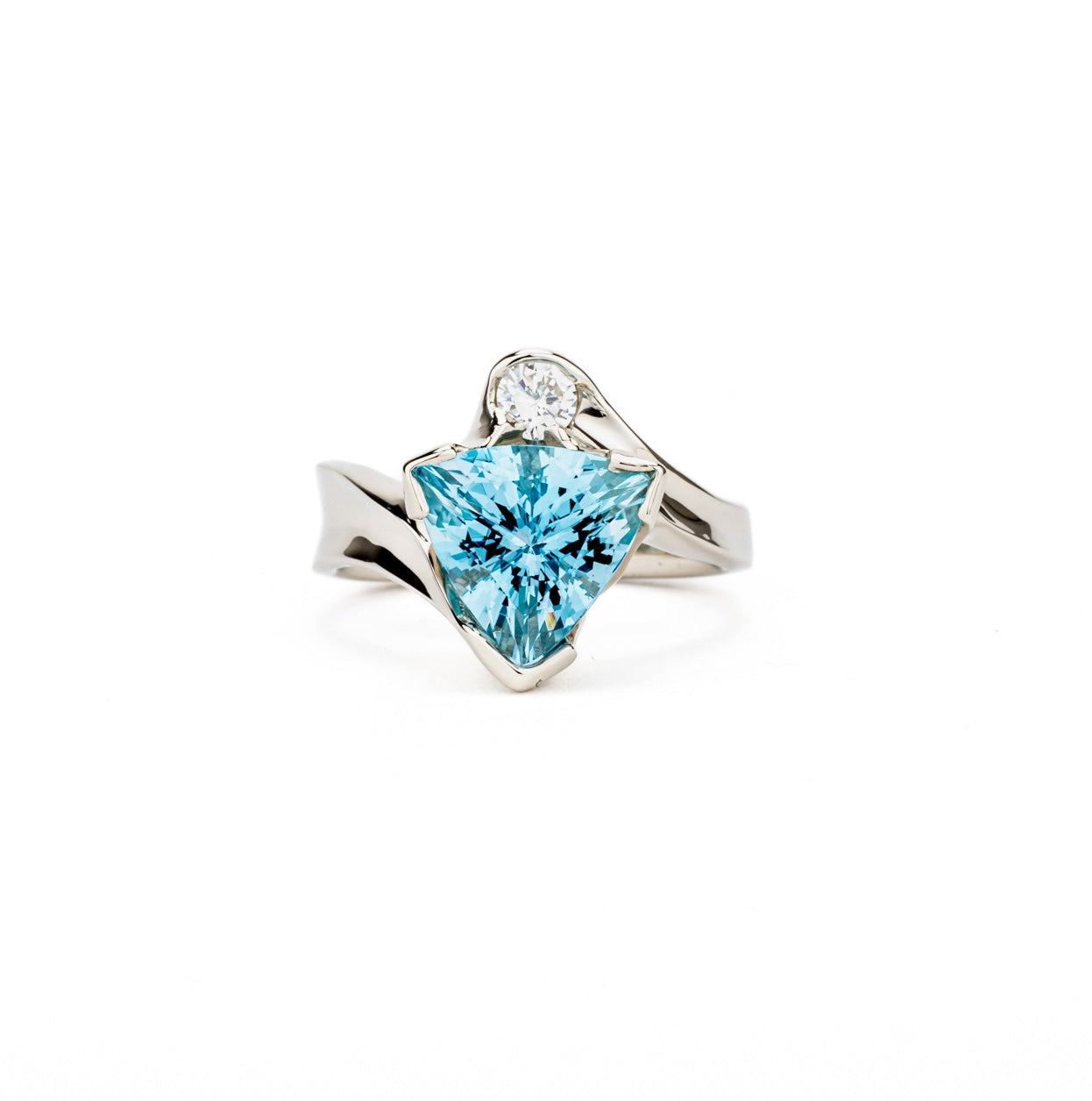 One-of-a-kind 14K white gold ring featuring a trillium-cut aquamarine with a bezel-set round diamond accent