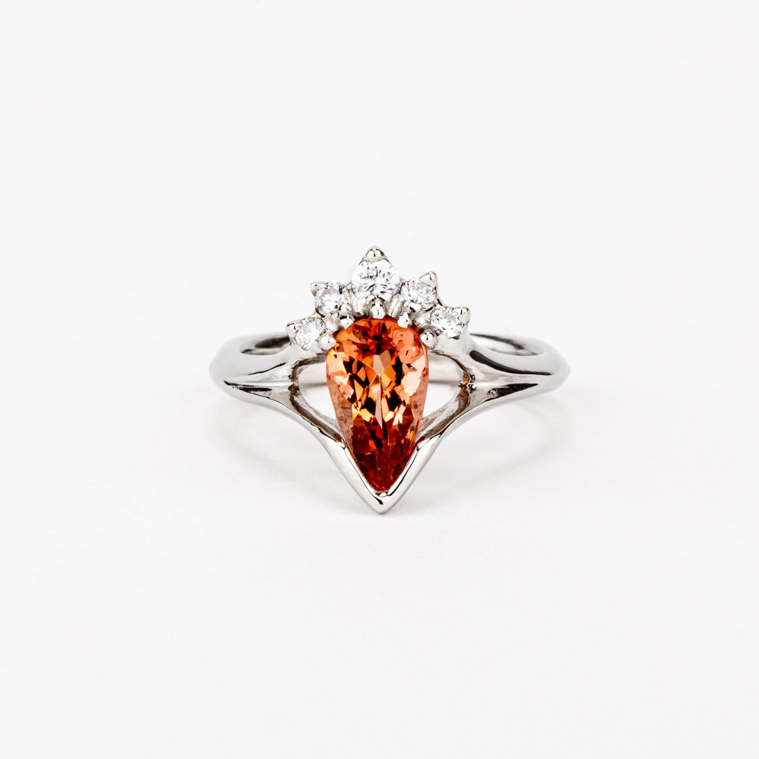 One-of-a-kind platinum ring featuring an inverted pear-shaped Imperial Topaz with a diamond crown halo