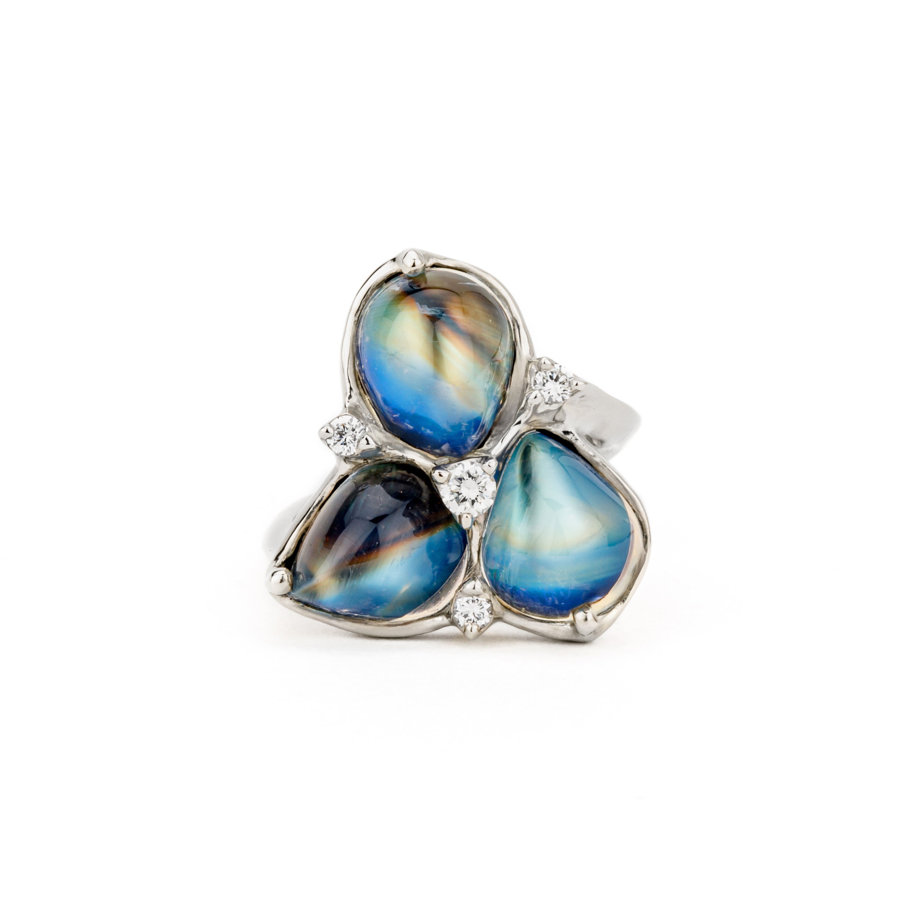 14k white gold cocktail ring featuring three pear-shaped moonstone cabochons totaling 10.70ct with round diamond accents