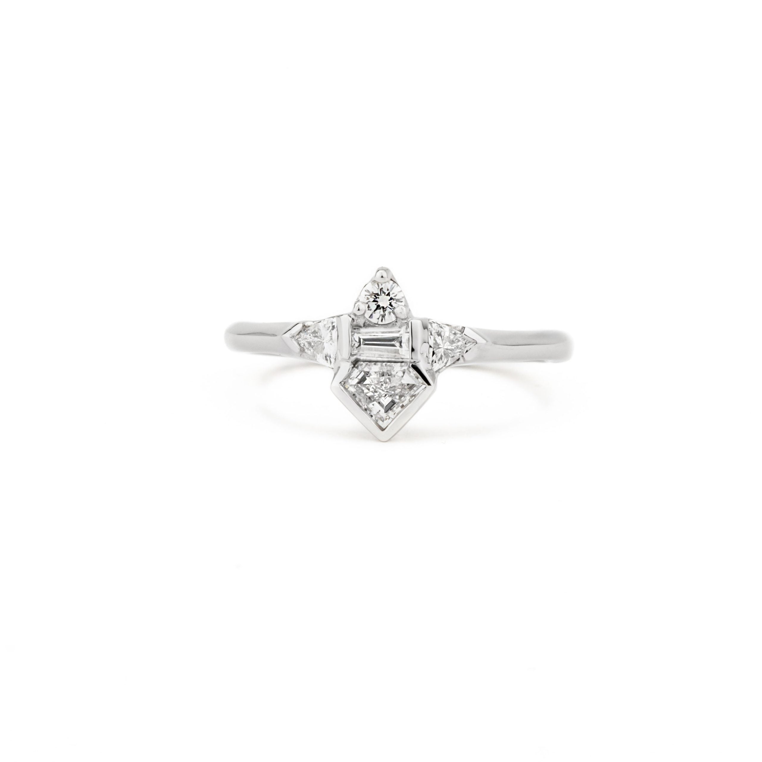 One of a kind platinum shield diamond ring with baguette, round and triangle diamond accents